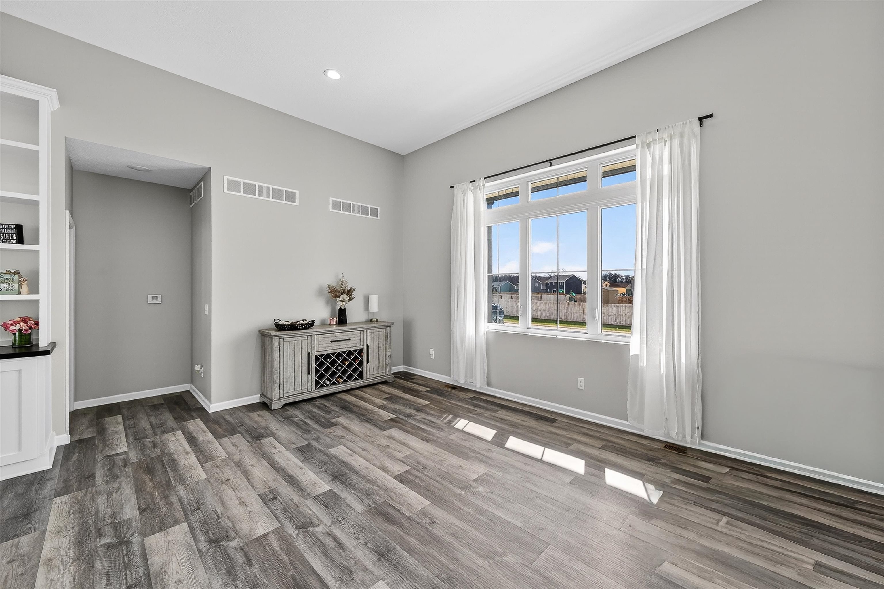 Spare room featuring light wood-style floors could be Formal Dining or part of Great Room