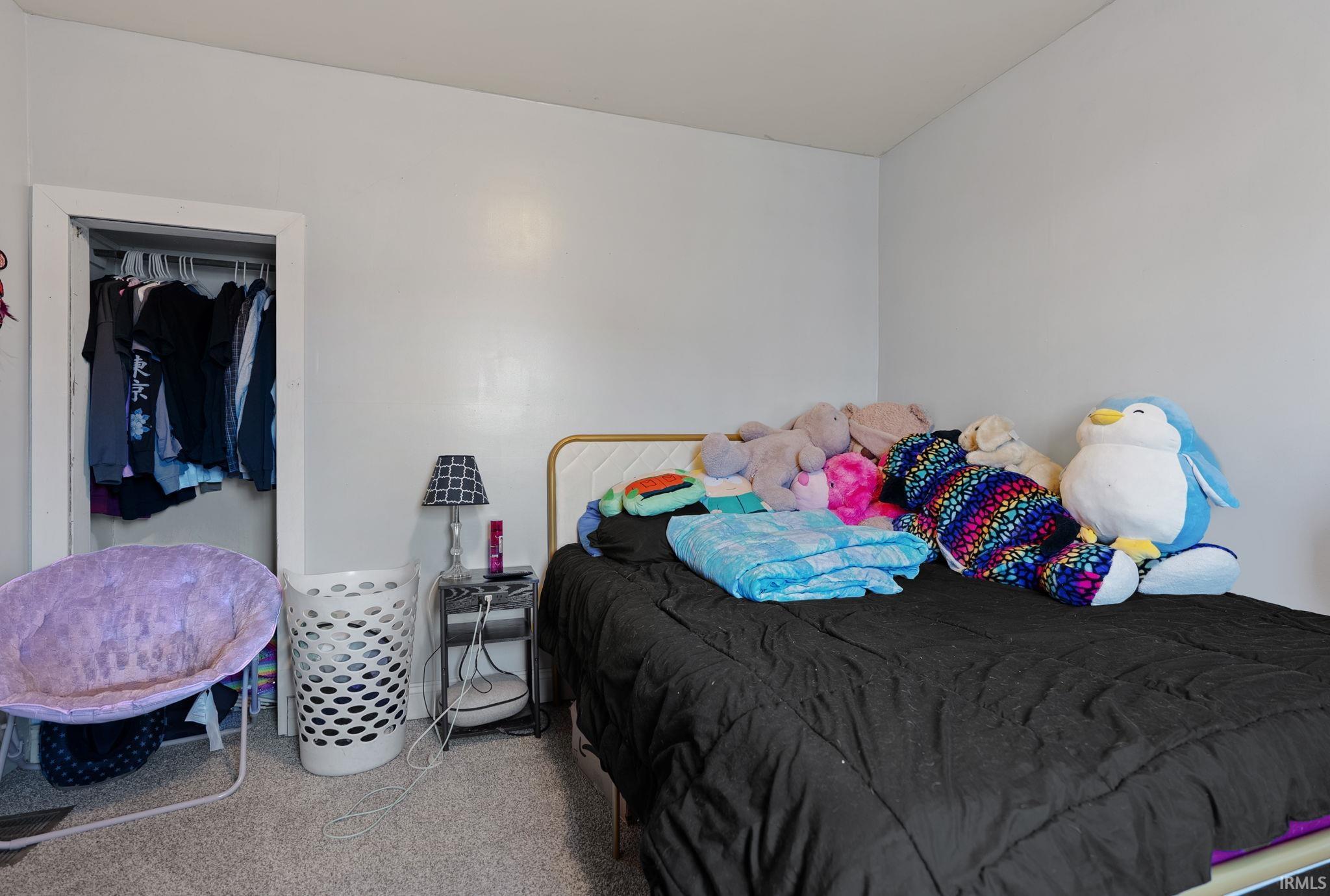 Bedroom featuring a closet and carpet flooring