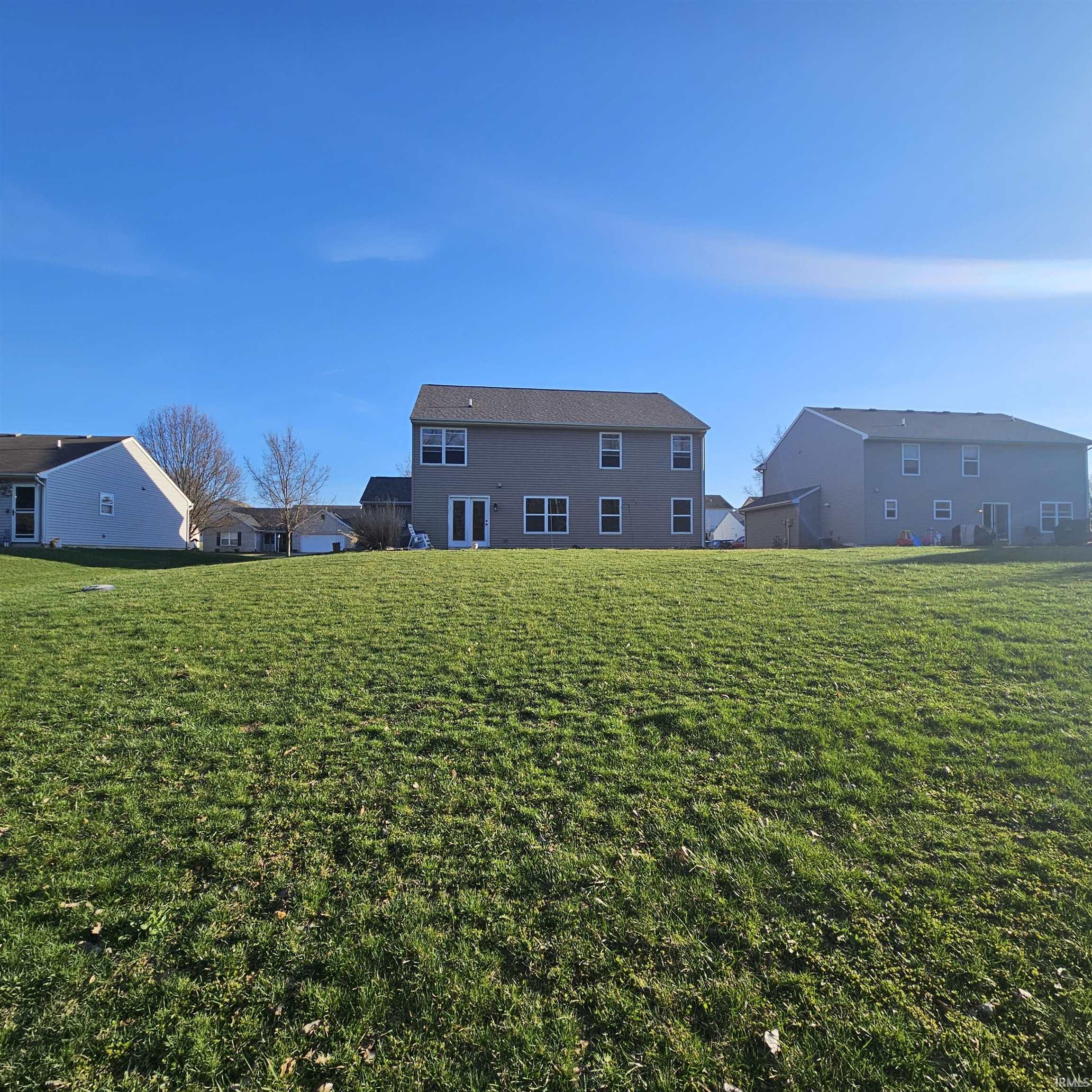 Back of property featuring a yard