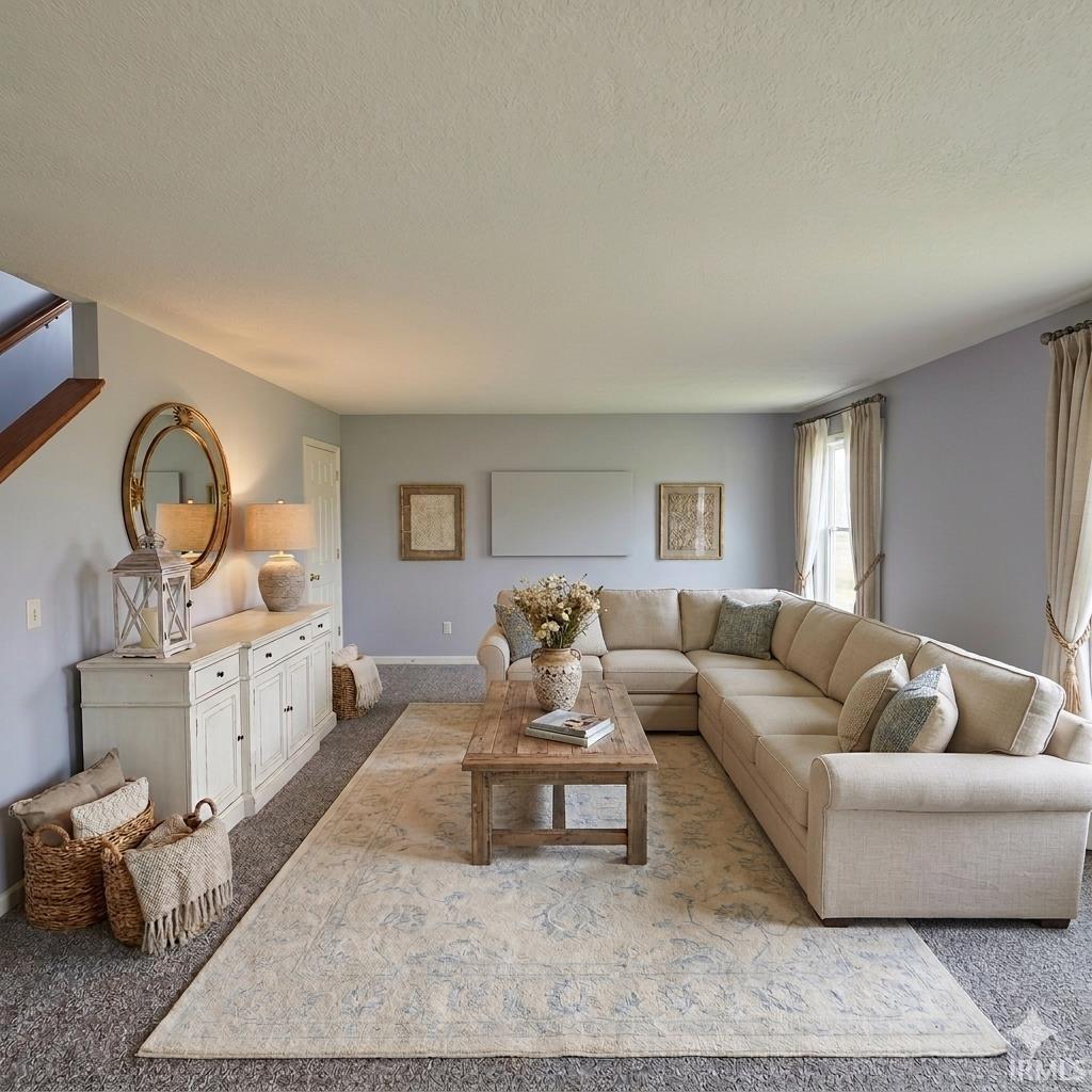 Living room featuring carpet and a textured ceiling
