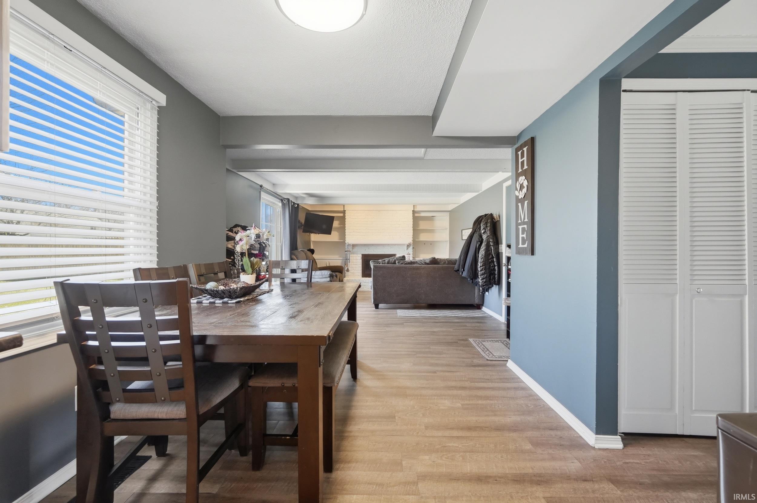 Dining room featuring light wood-type flooring and a fireplace