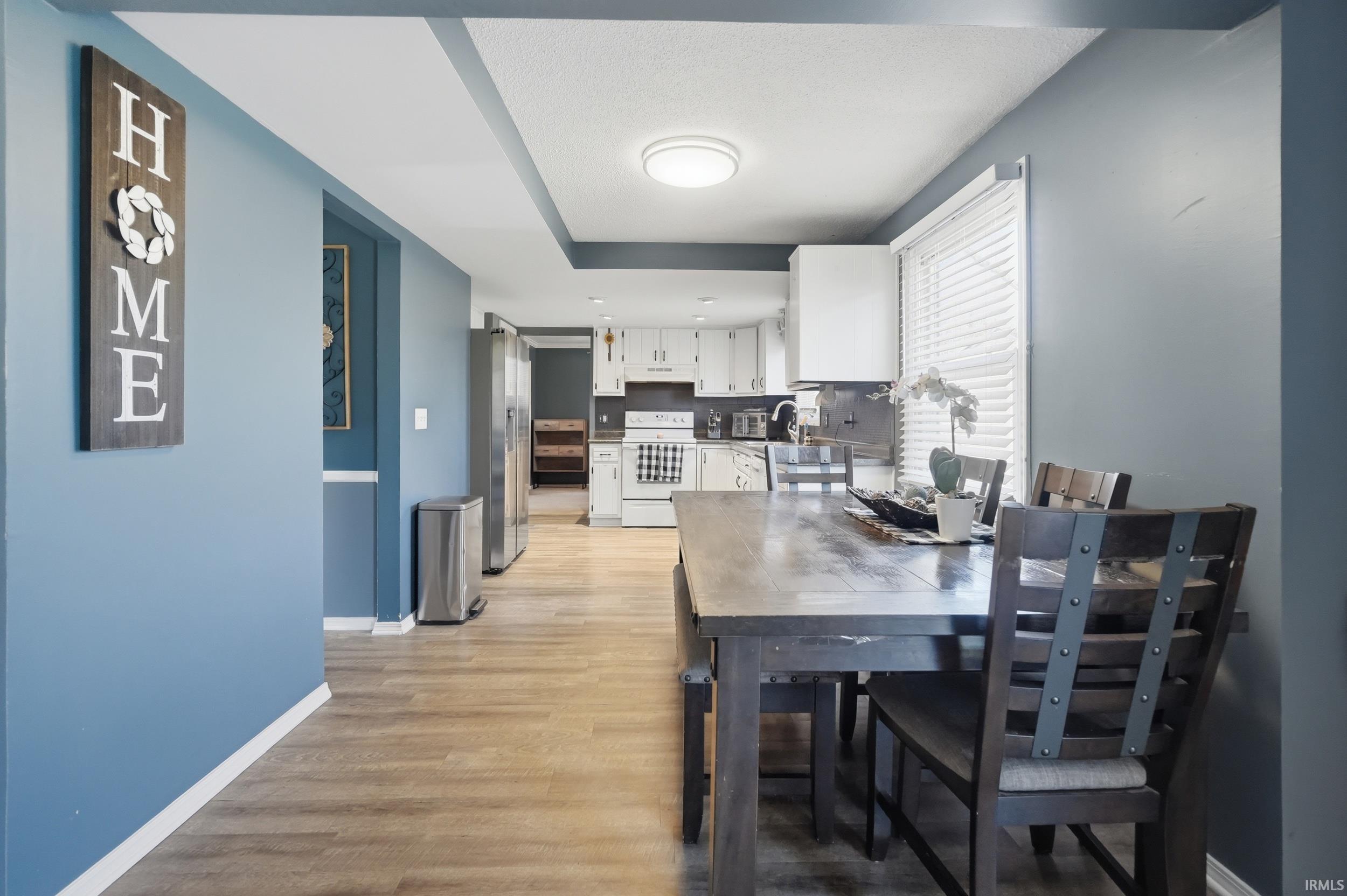 Dining room with light wood-style flooring and baseboards