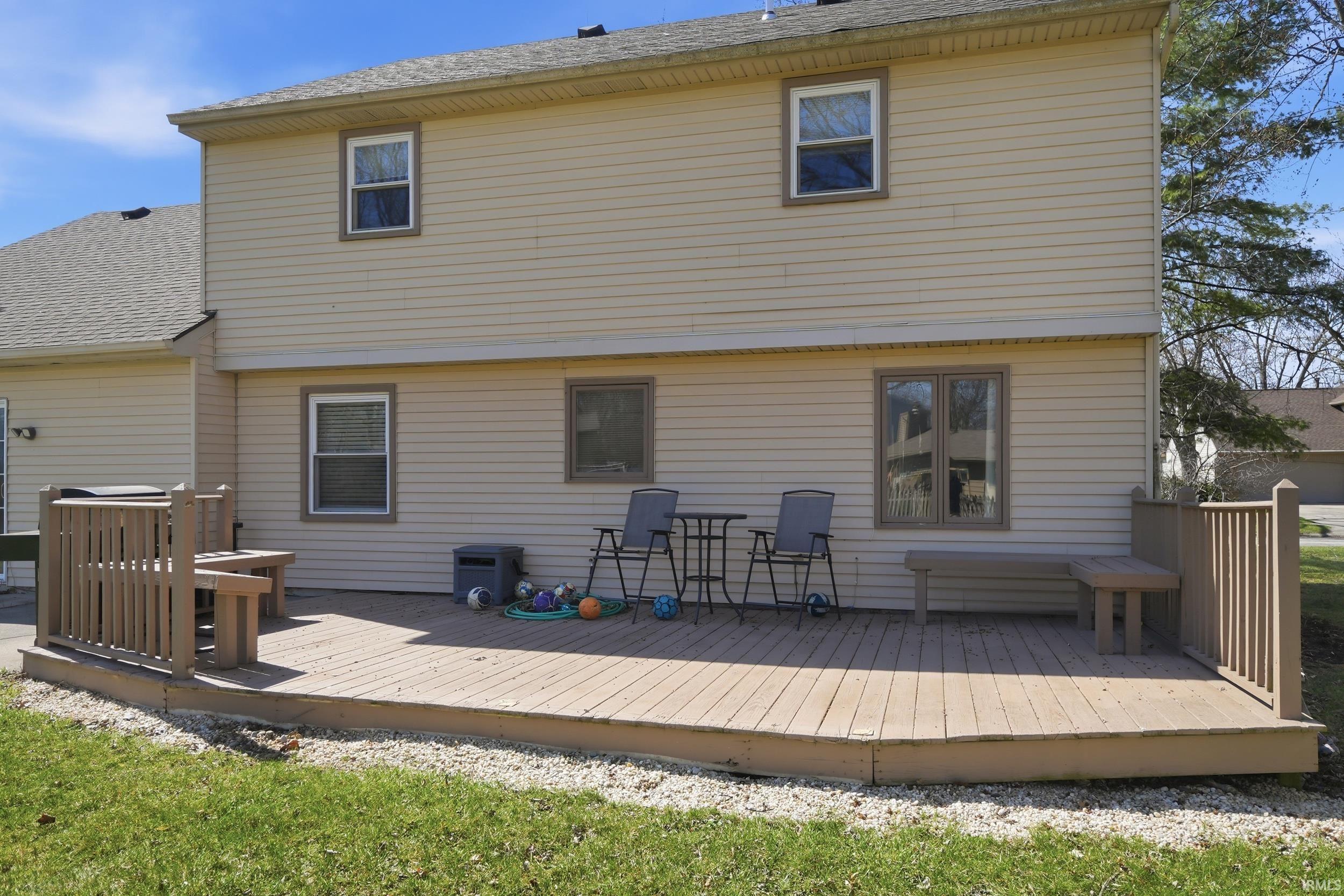Back of house with a wooden deck and a shingled roof