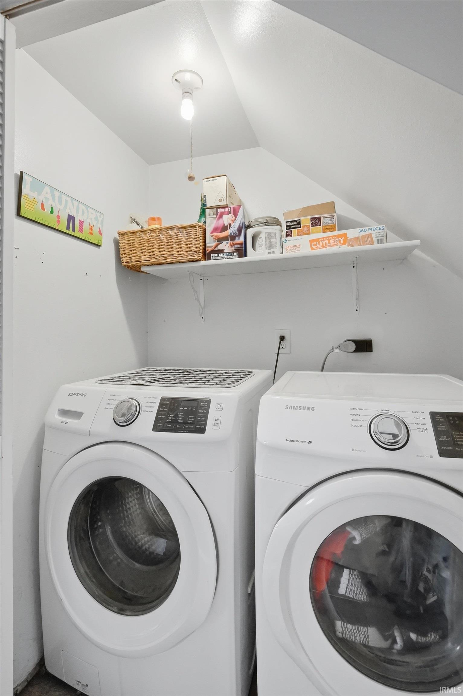 Laundry area featuring washing machine and clothes dryer and lofted ceiling