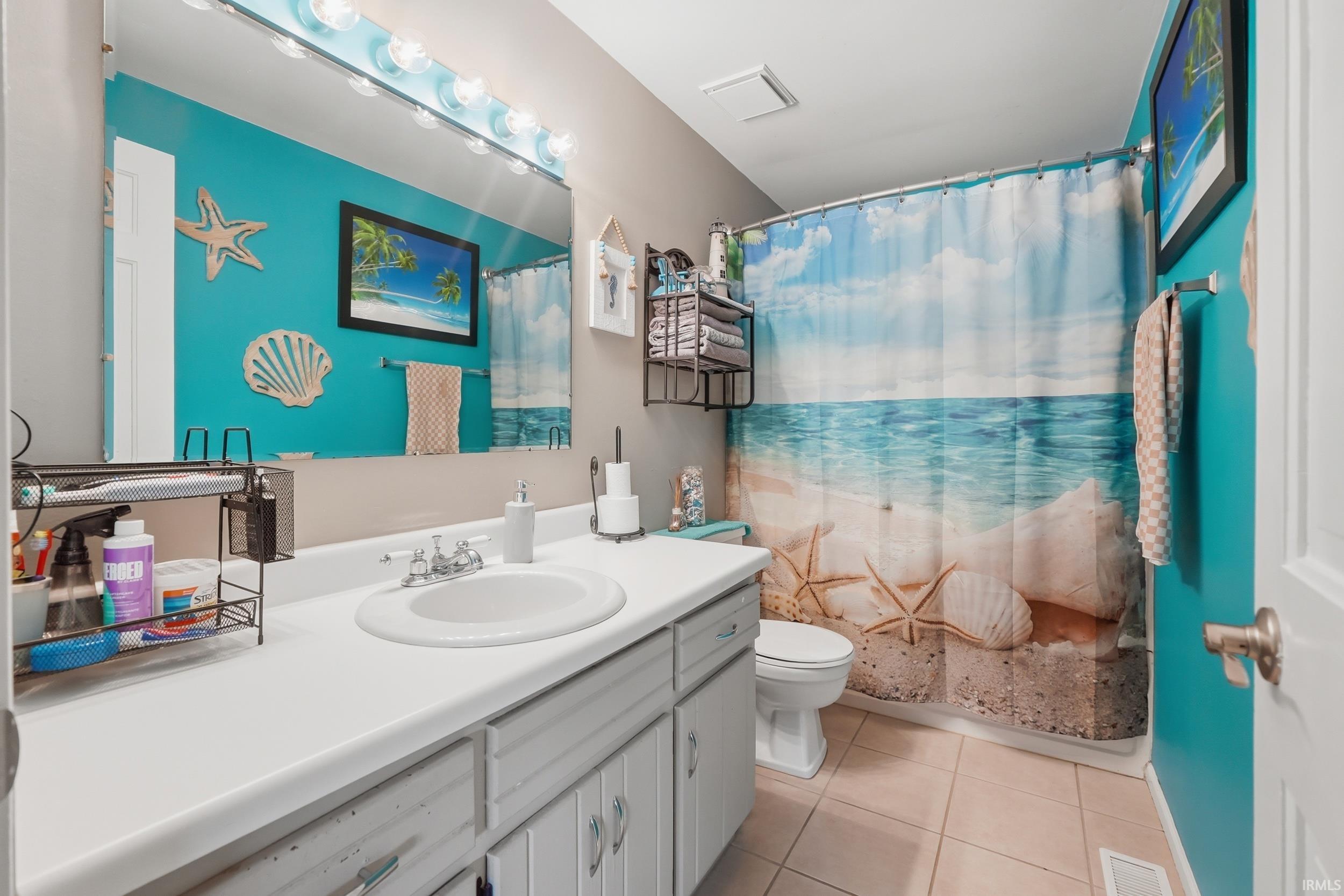 Bathroom with vanity and light tile patterned floors
