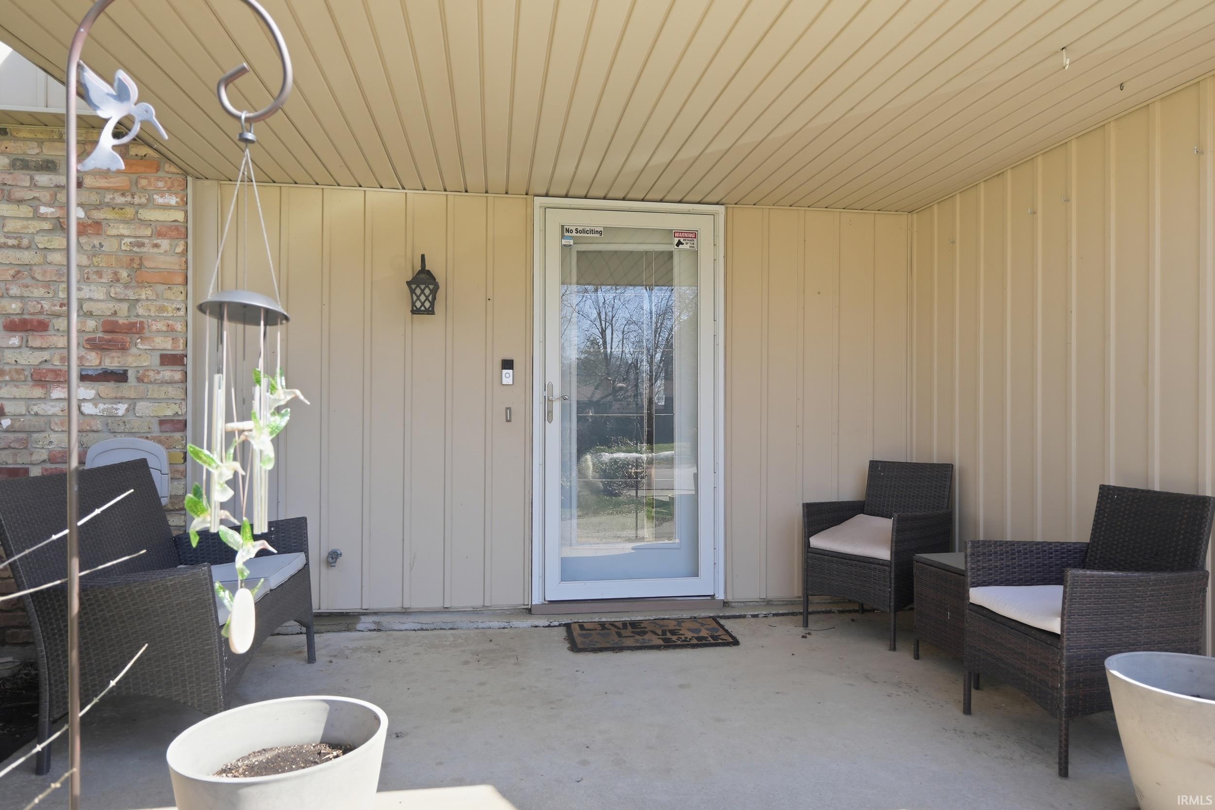 View of exterior entry featuring a patio area