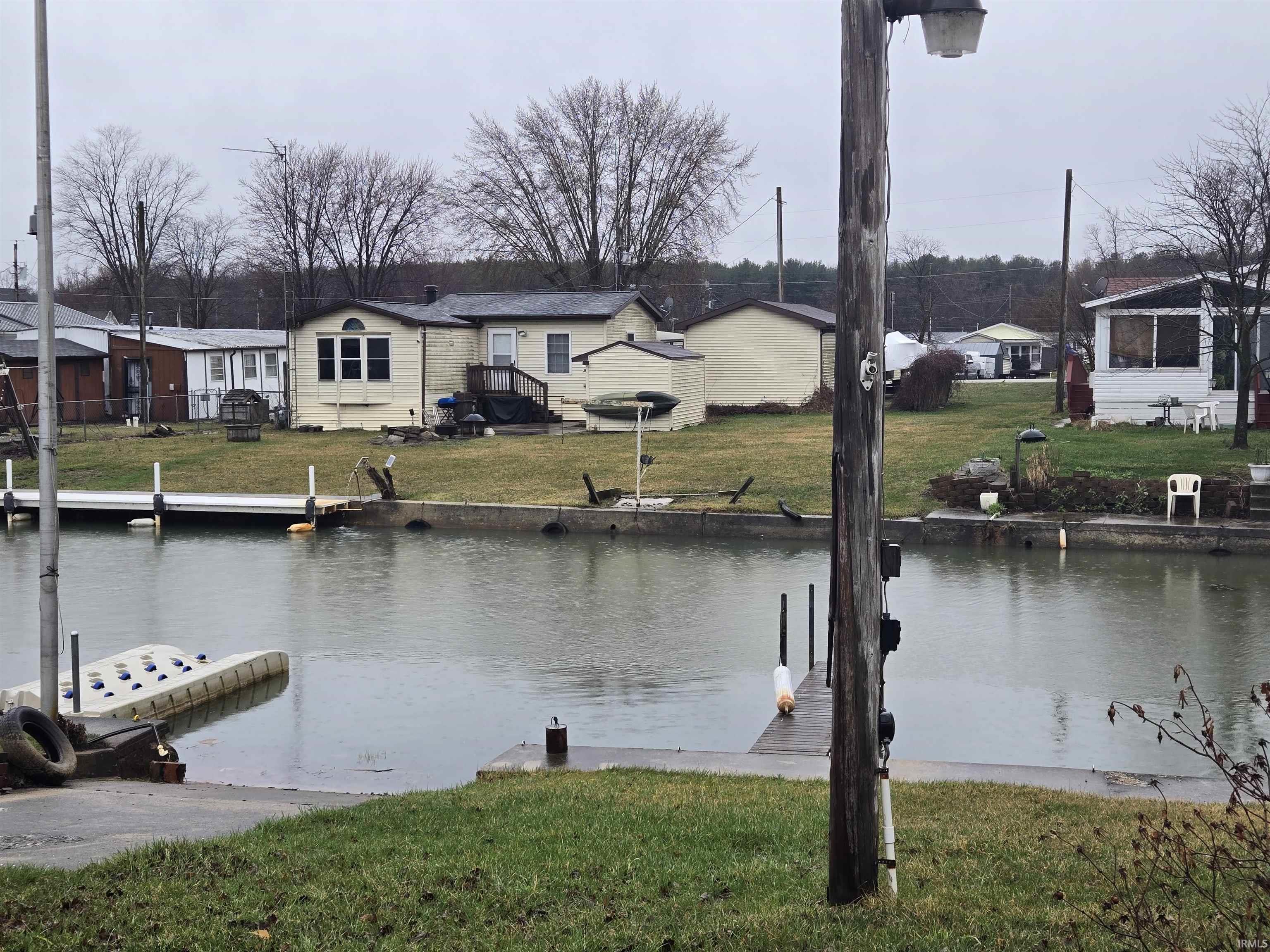 Dock with a yard, a water view, and a residential view