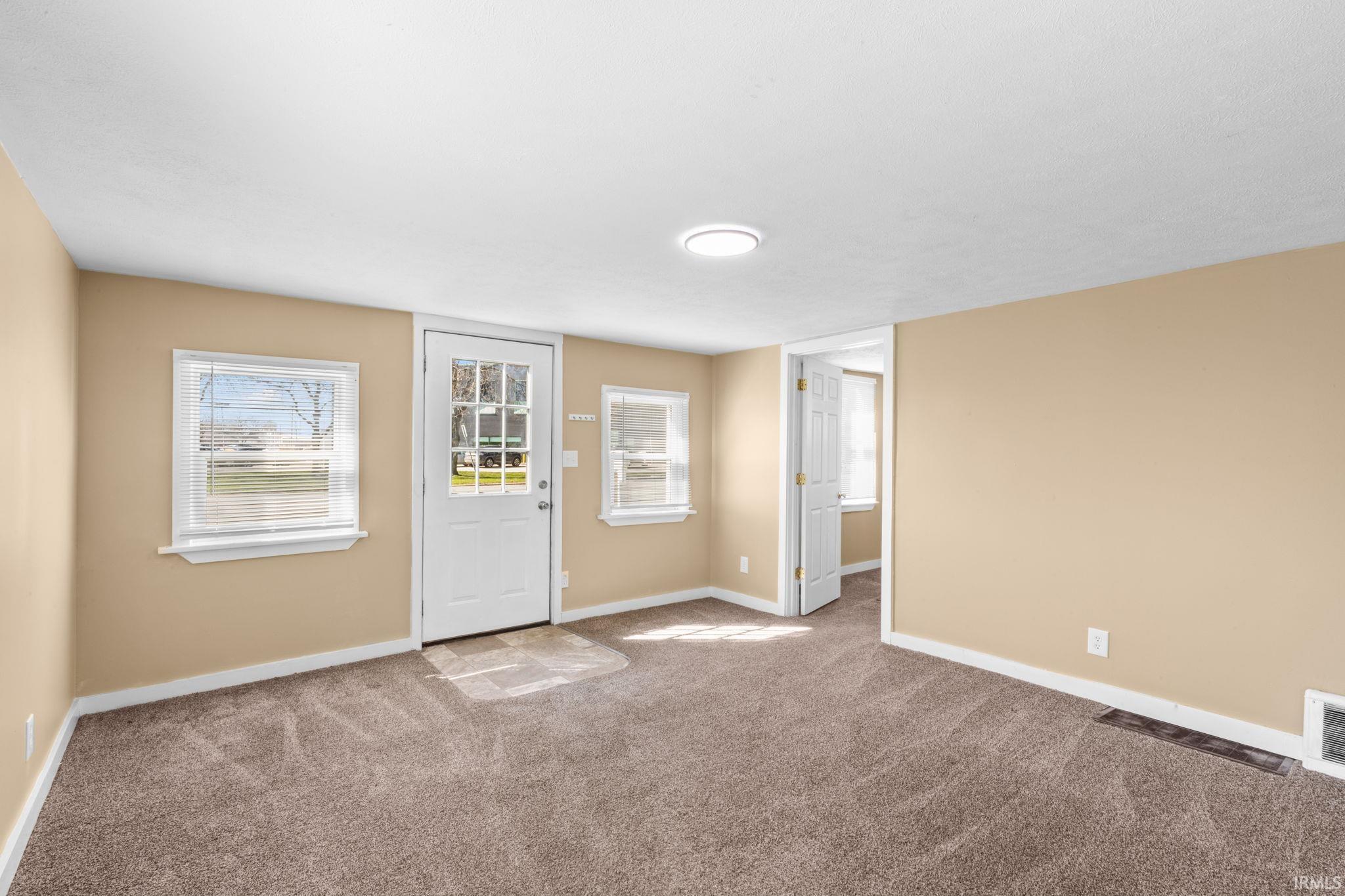 Spare room with baseboards and carpet flooring
