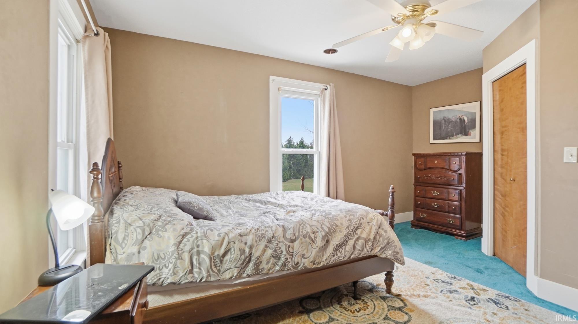 Bedroom featuring carpet flooring and ceiling fan