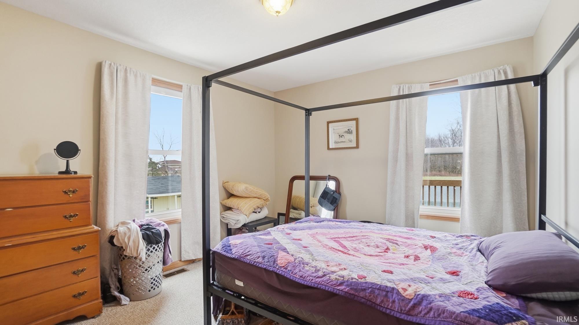 Bedroom with light colored carpet