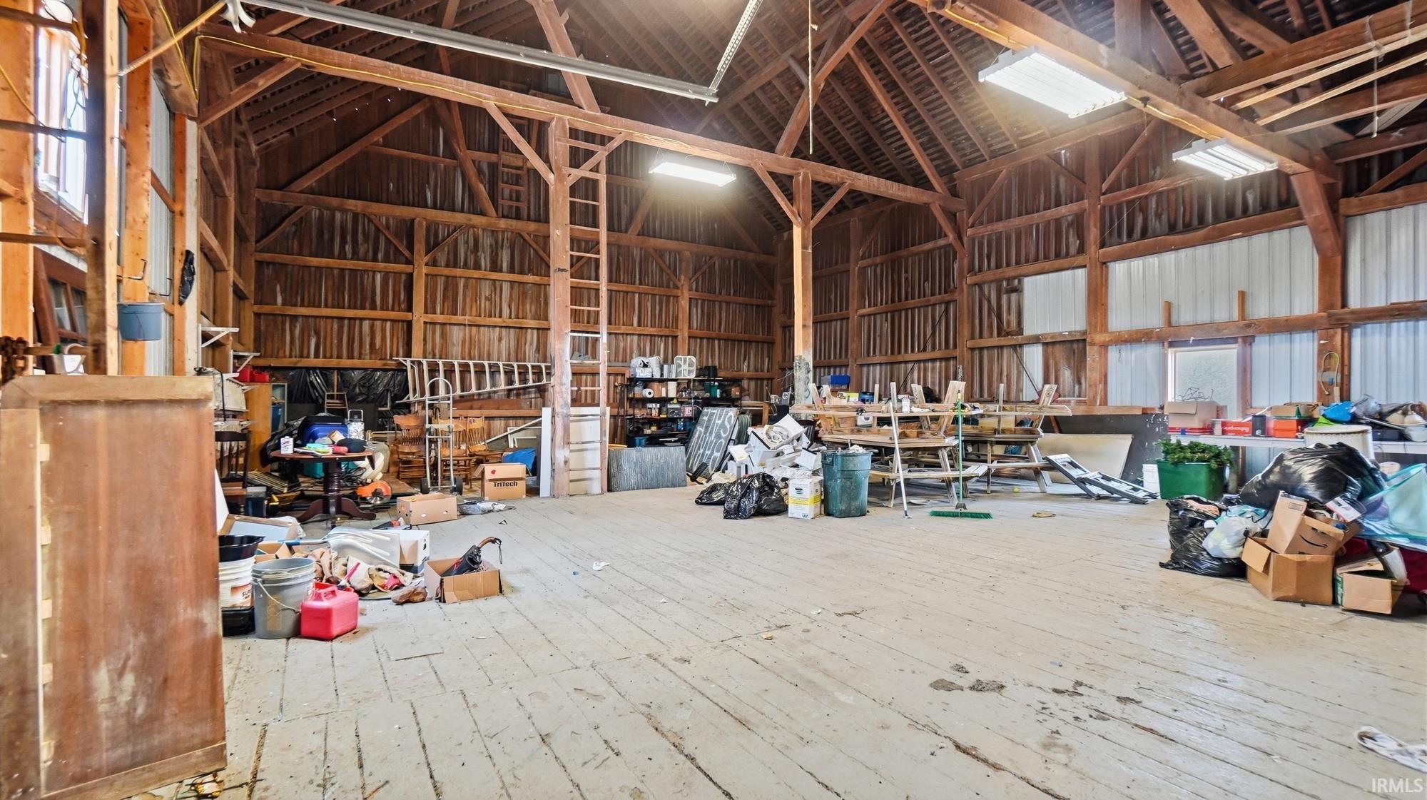 Misc room featuring a high ceiling and hardwood / wood-style floors