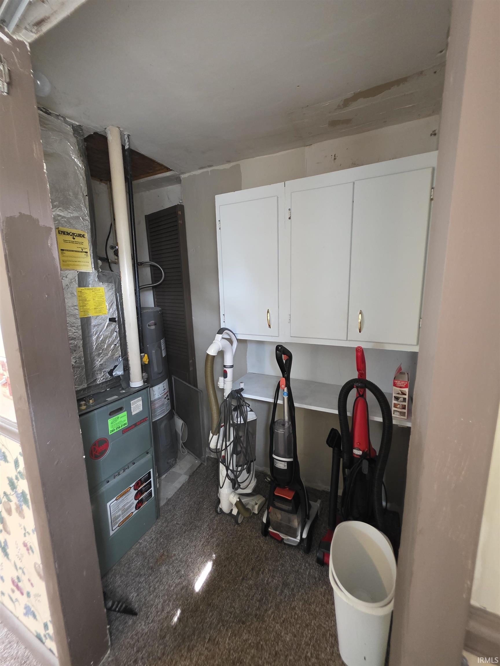 Utility room featuring electric water heater
