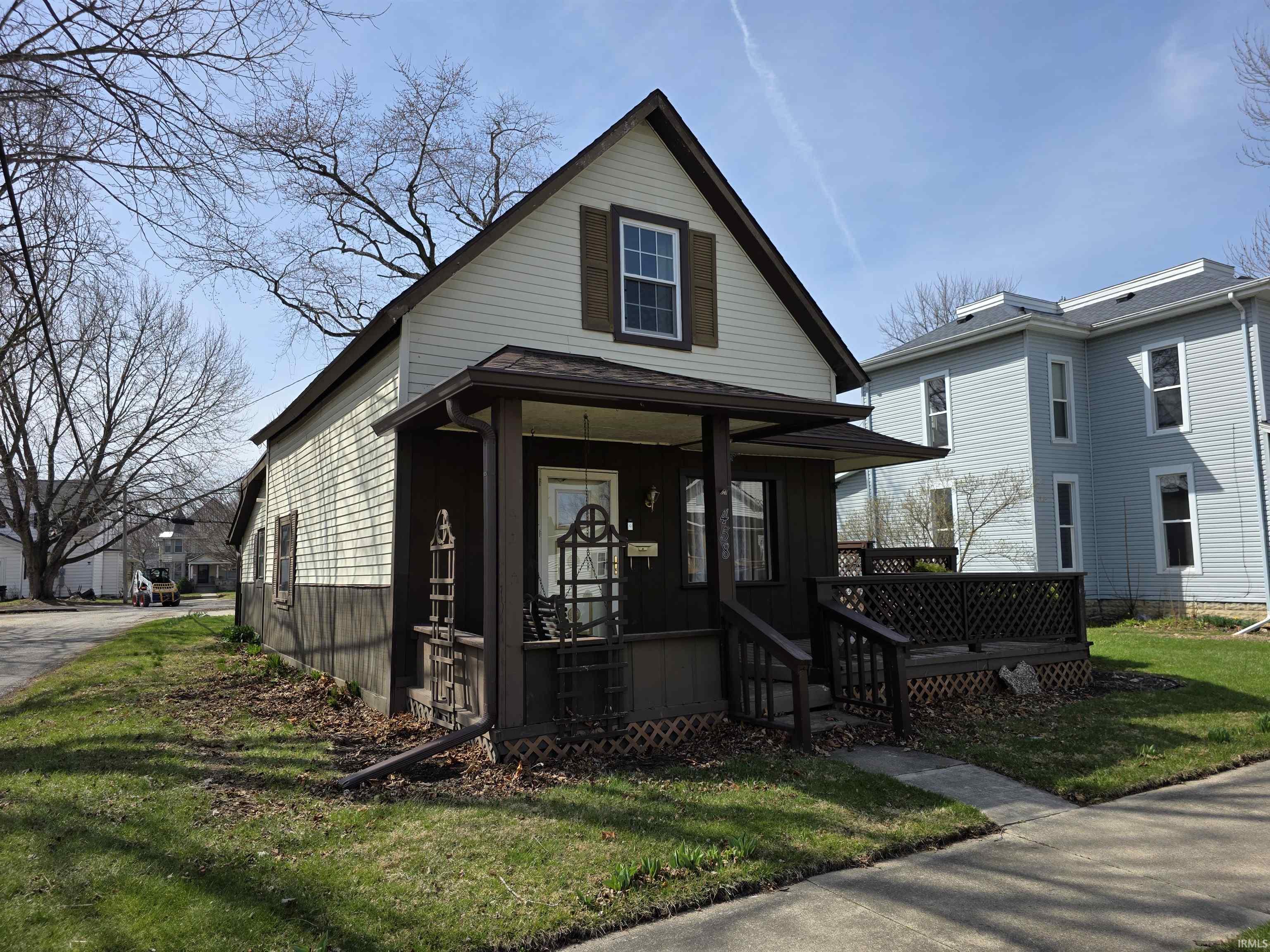 View of front of property with a front lawn and covered porch