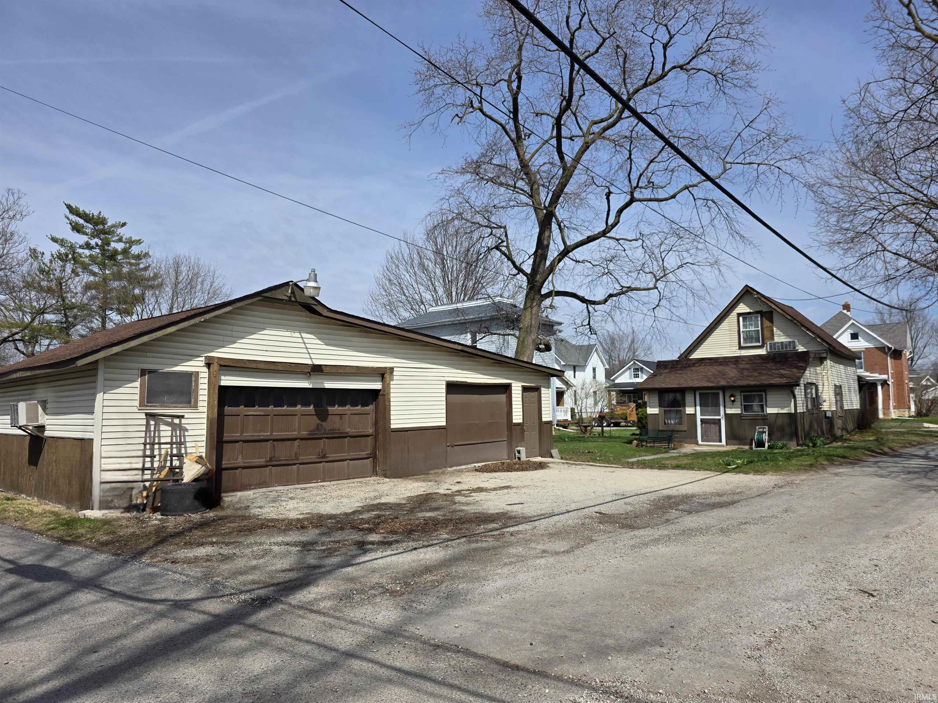 View of home's exterior featuring an outbuilding, a garage, and a residential view