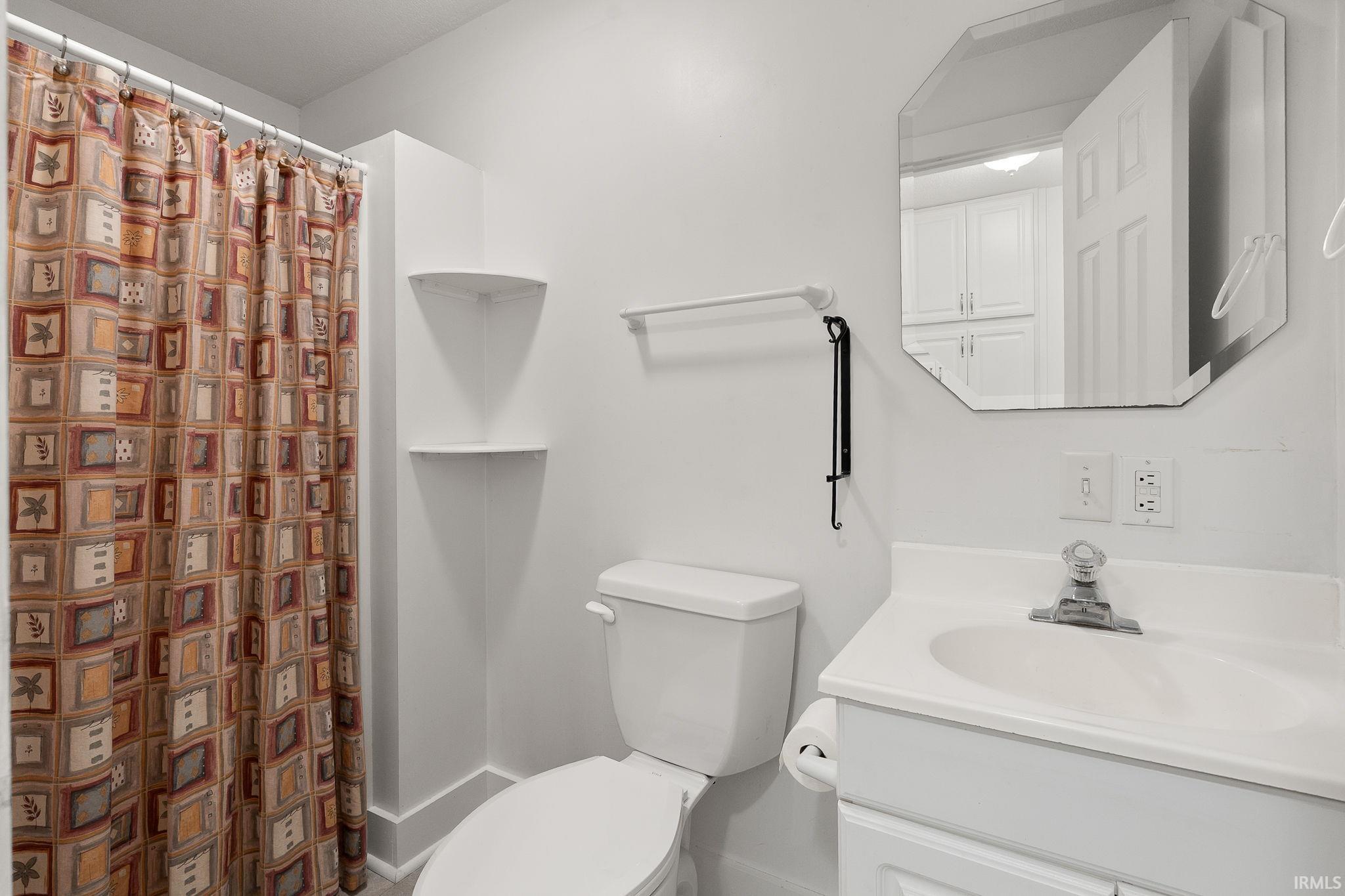 Full bath featuring vanity and a shower with curtain