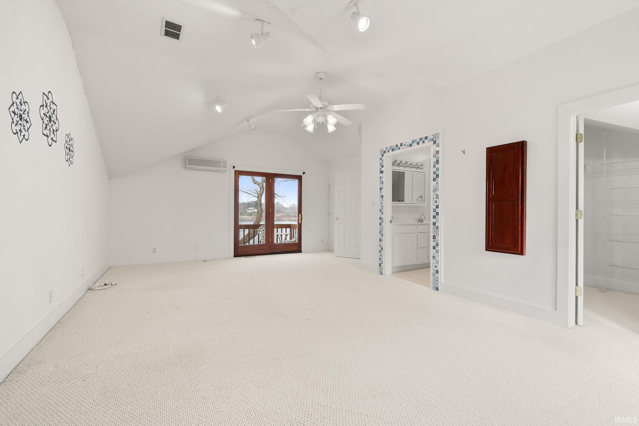 Bonus room featuring light carpet and a ceiling fan