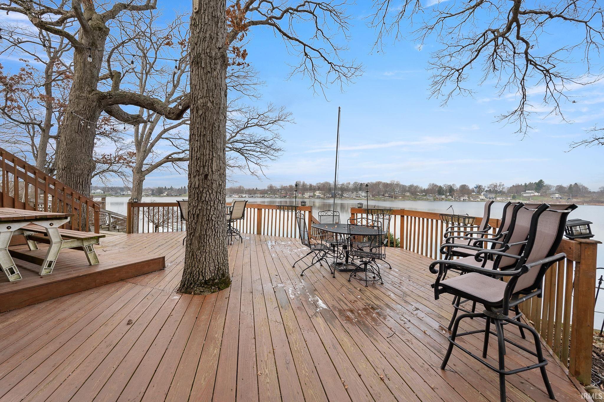 Wooden deck with outdoor dining area and a water view