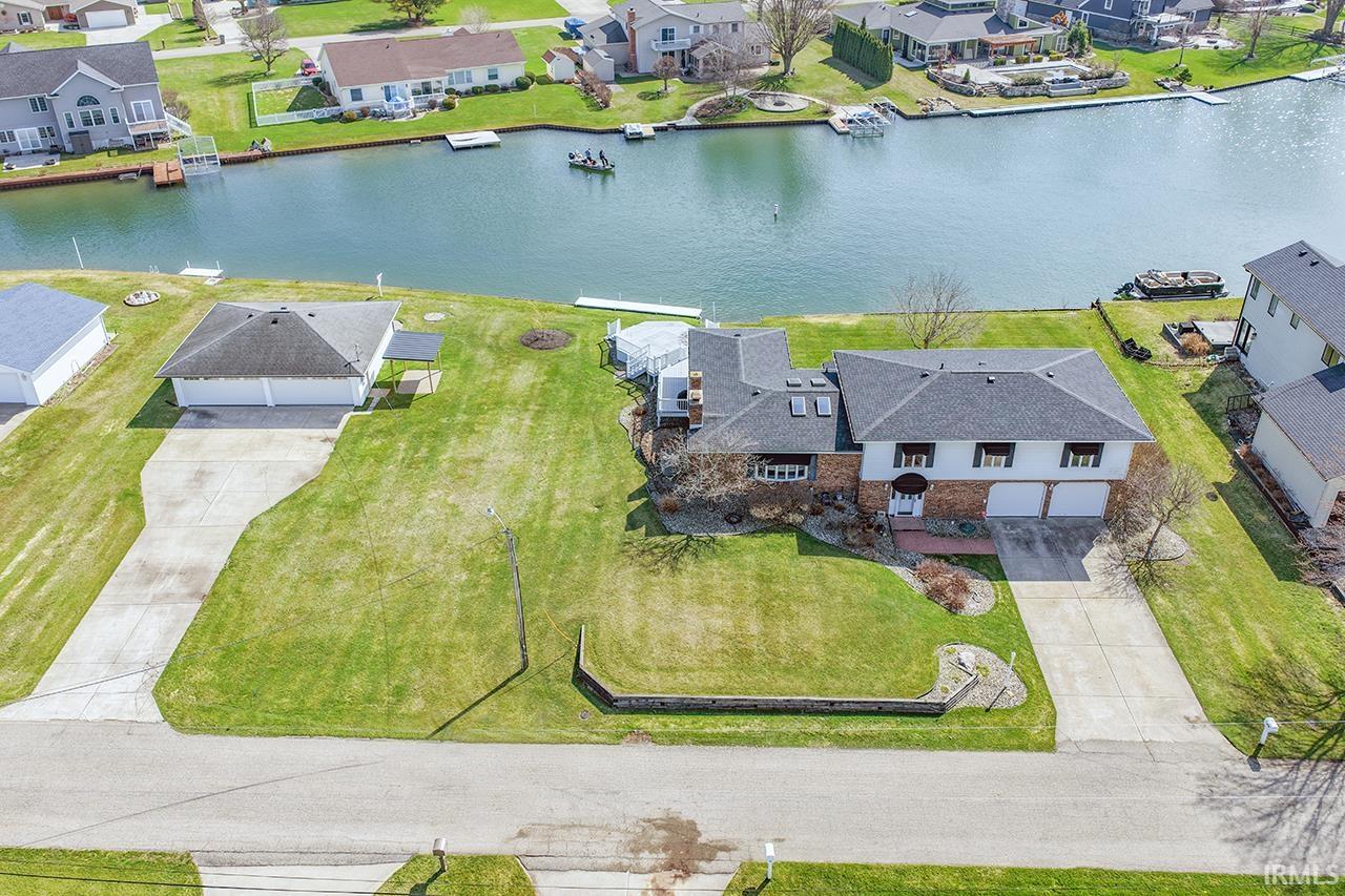 Aerial perspective of suburban area featuring a nearby body of water