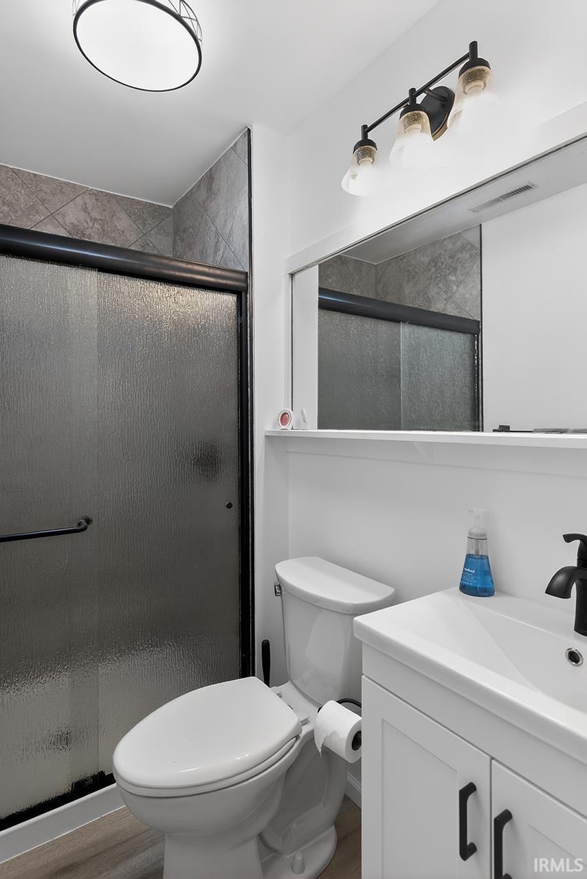 Bathroom featuring vanity and a stall shower