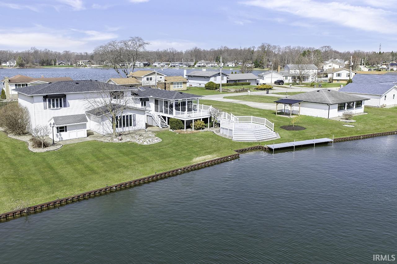 Aerial perspective of suburban area featuring a large body of water