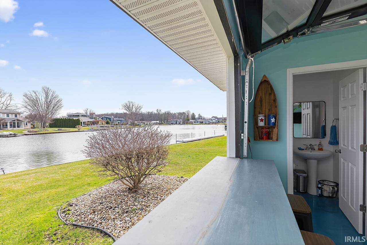detached garage with a water view and a residential view