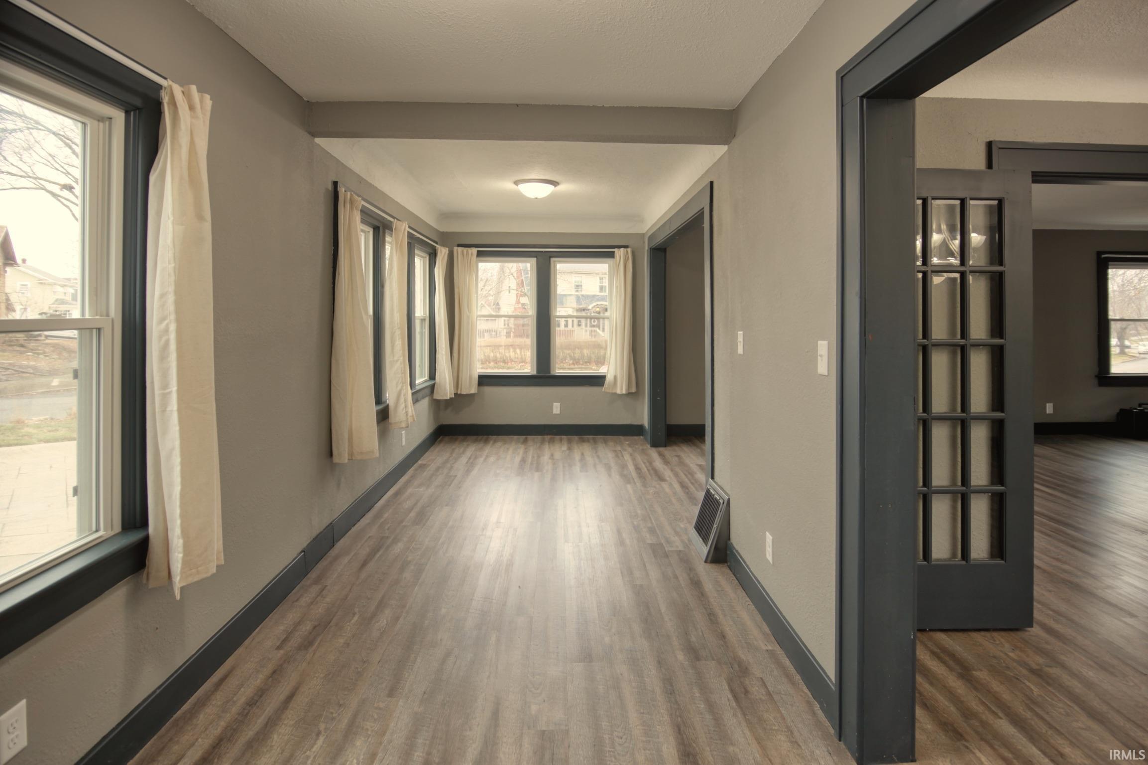 Hall with dark wood-style flooring