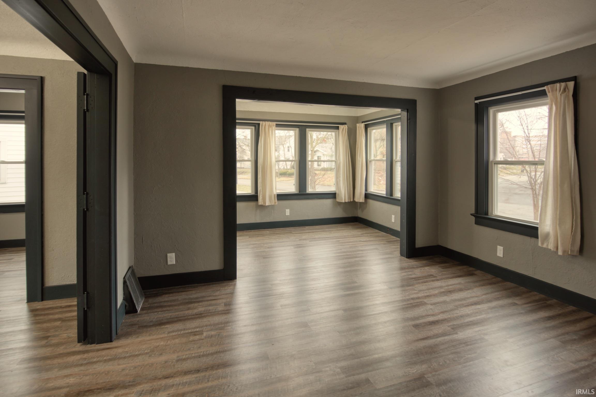 Spare room with wood finished floors and plenty of natural light