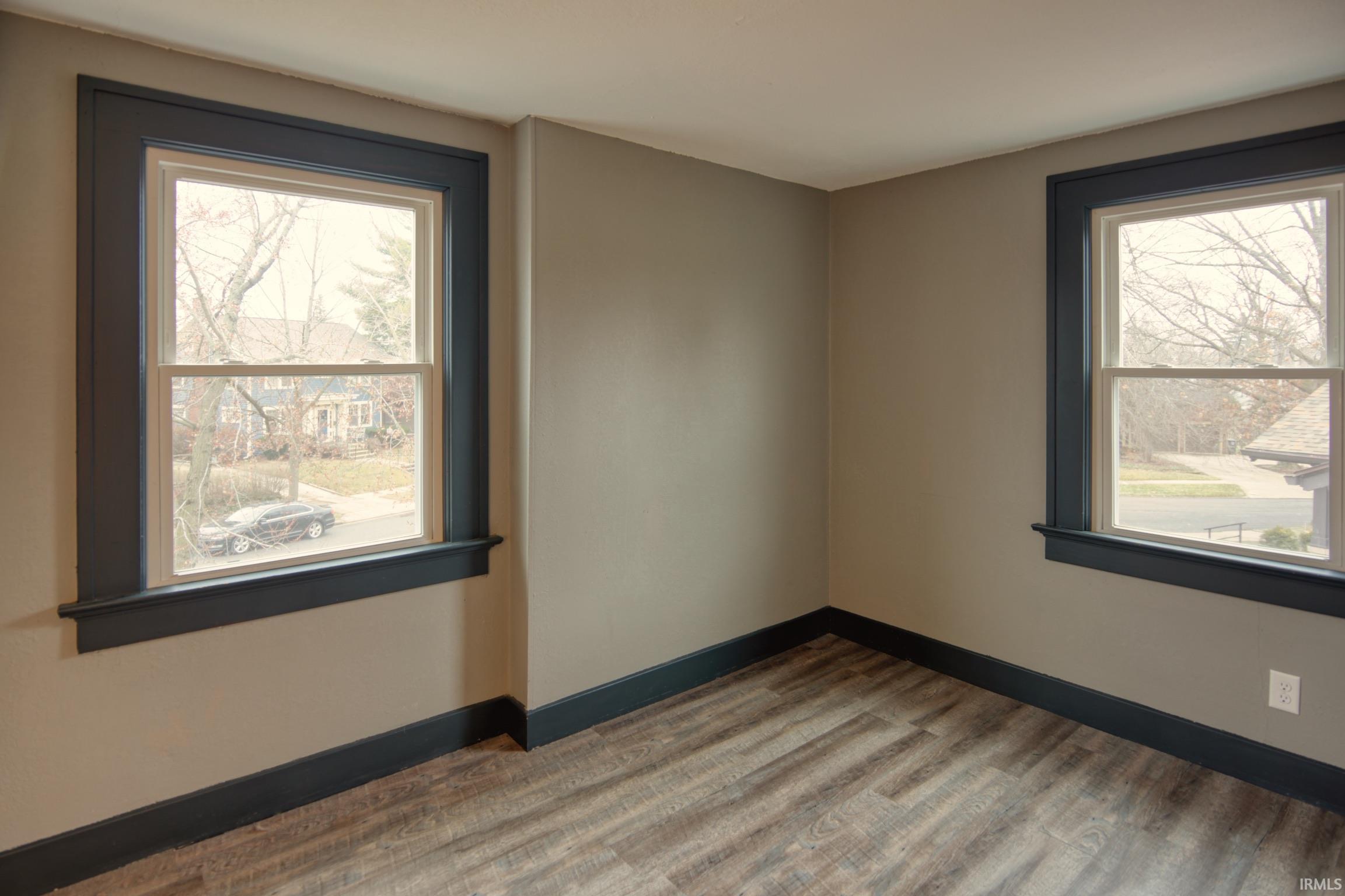 Empty room with baseboards and wood finished floors