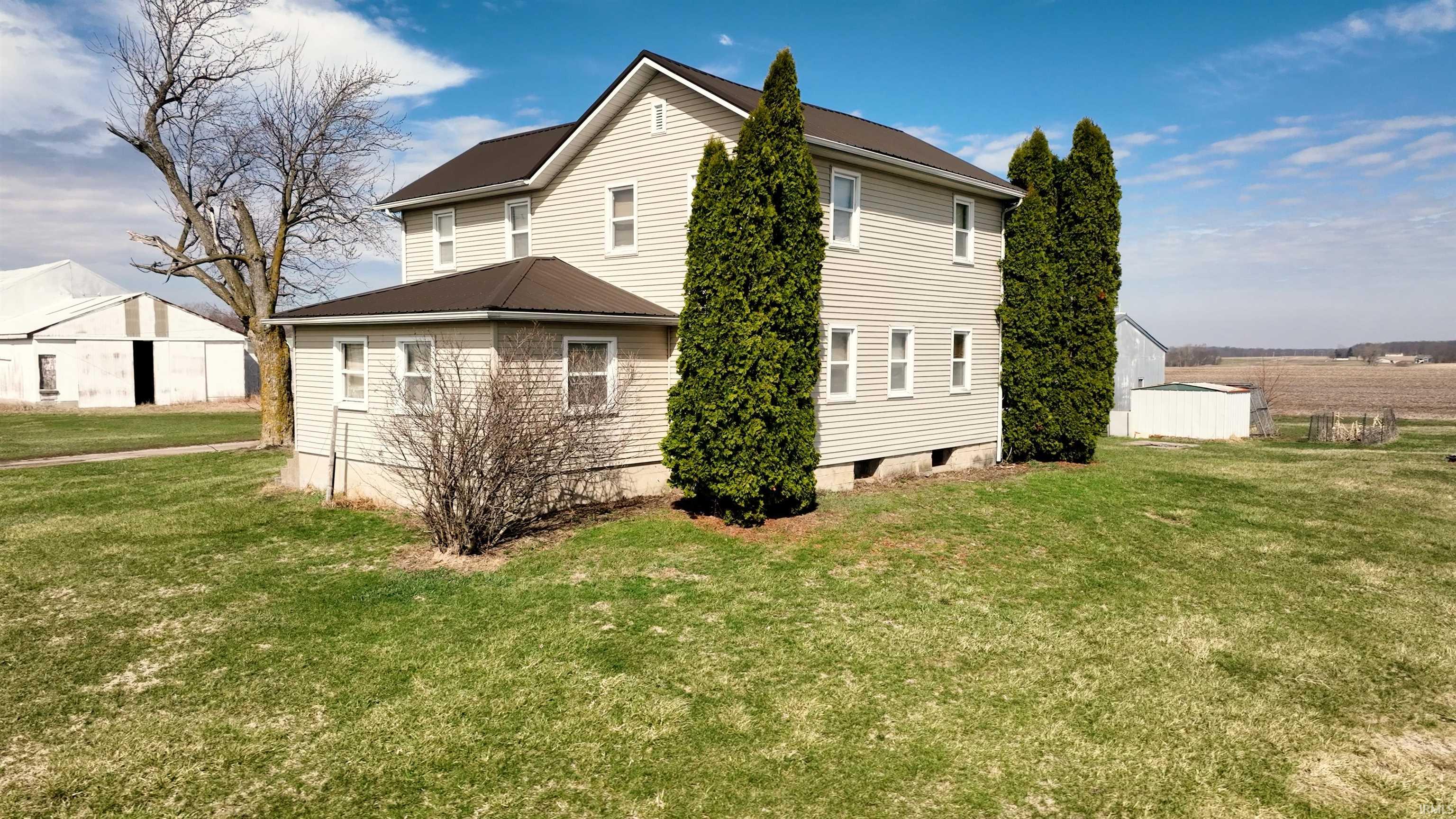 Rear view of house featuring a yard
