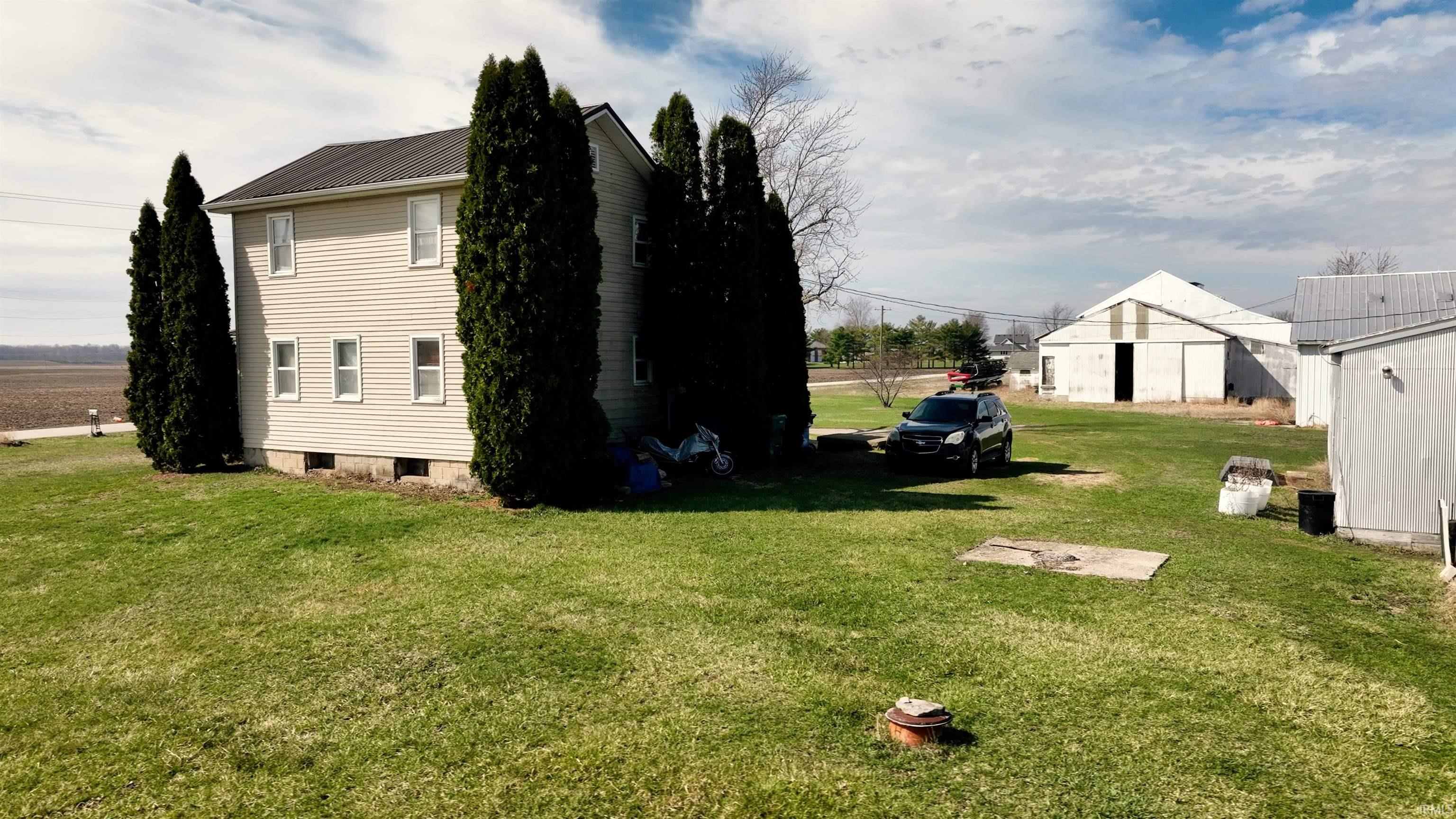View of home's exterior with a lawn and a metal roof