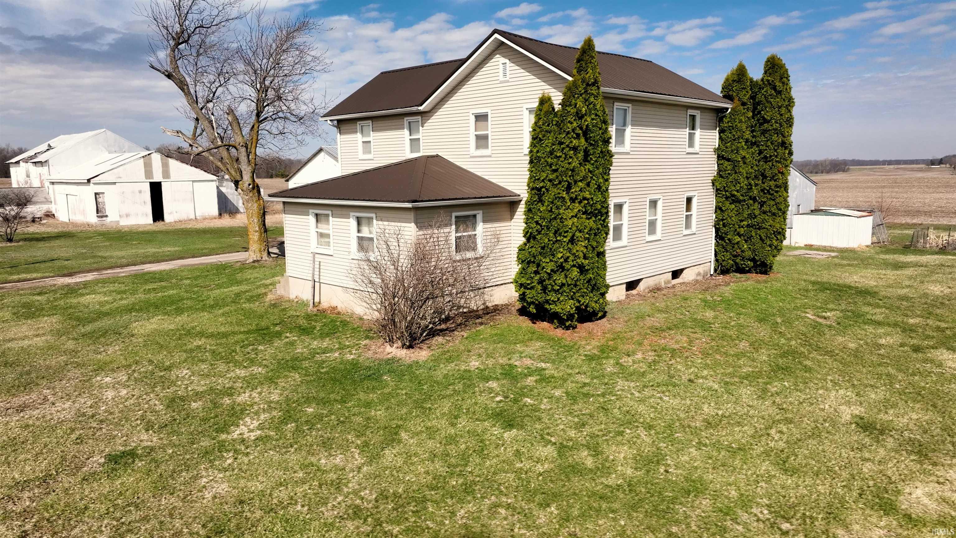 Rear view of property with a yard