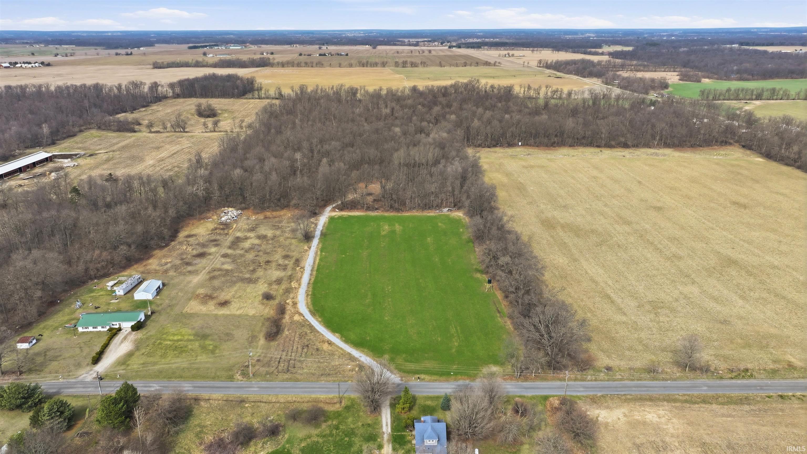 Aerial view of sparsely populated area with large plots for crops