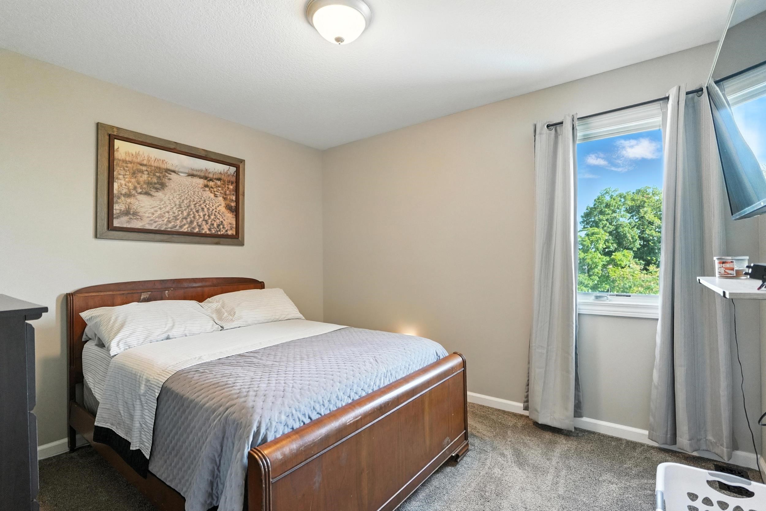 Carpeted bedroom with baseboards