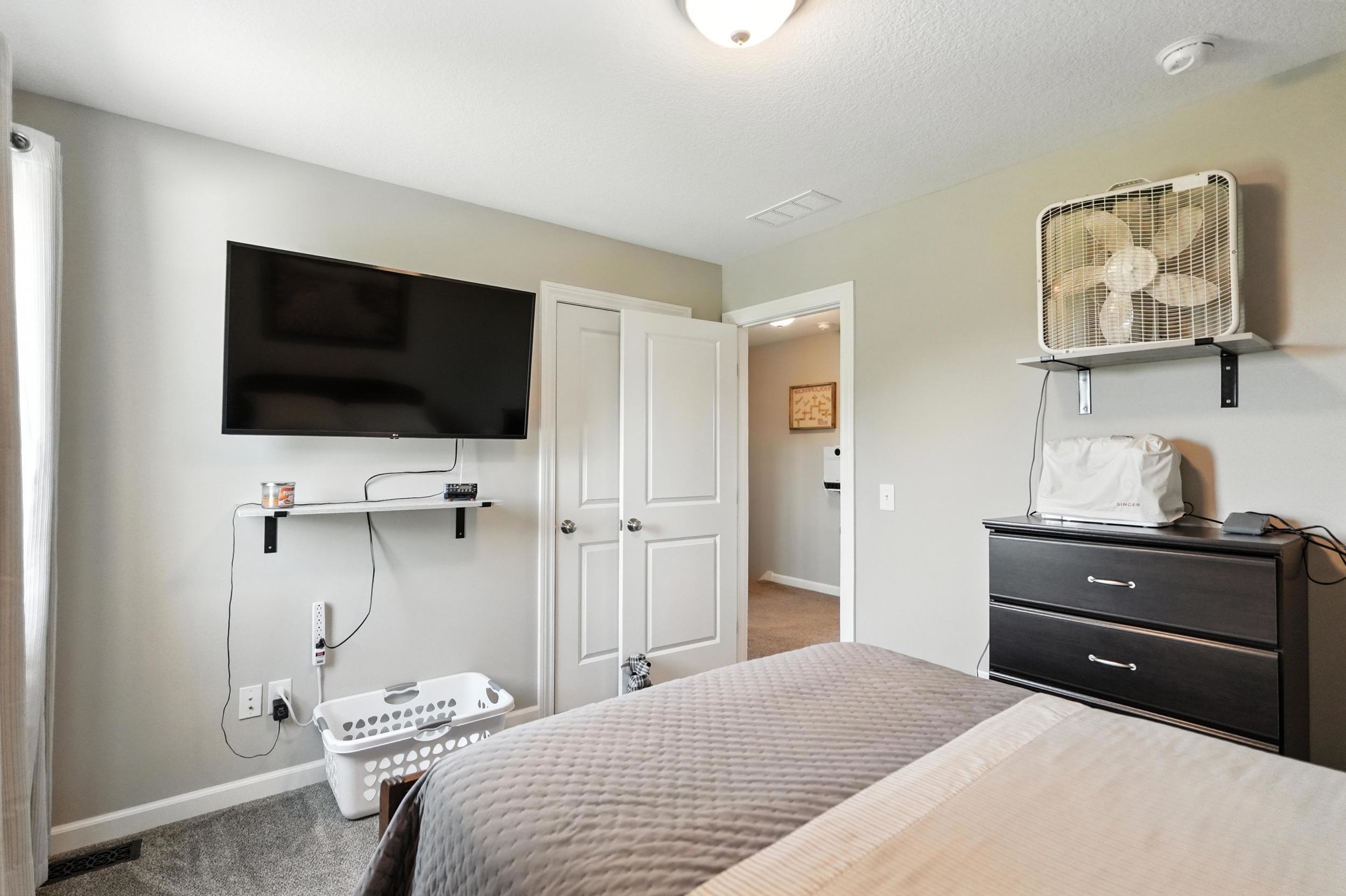 Carpeted bedroom featuring baseboards