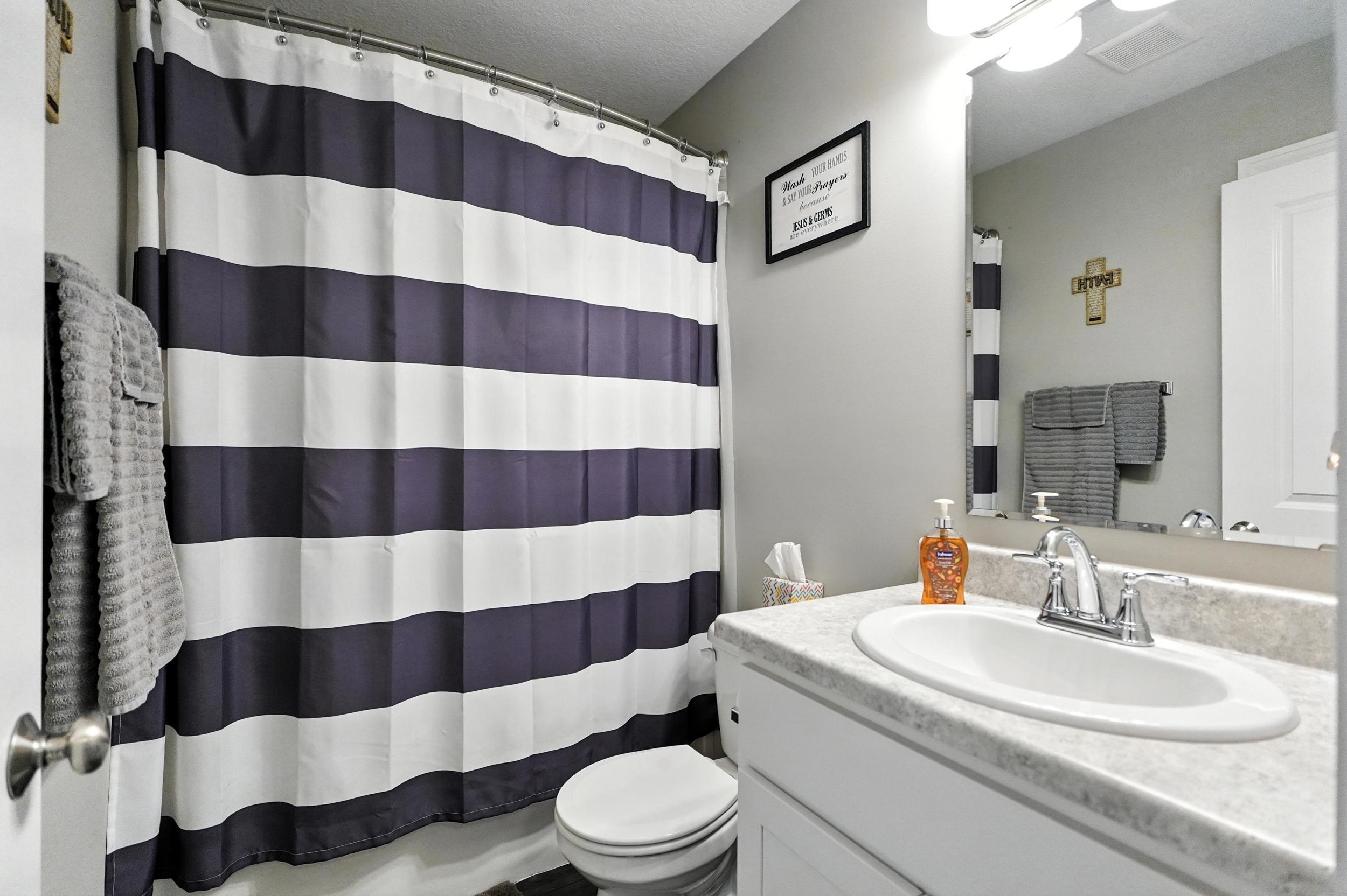 Full bath featuring vanity and a textured ceiling