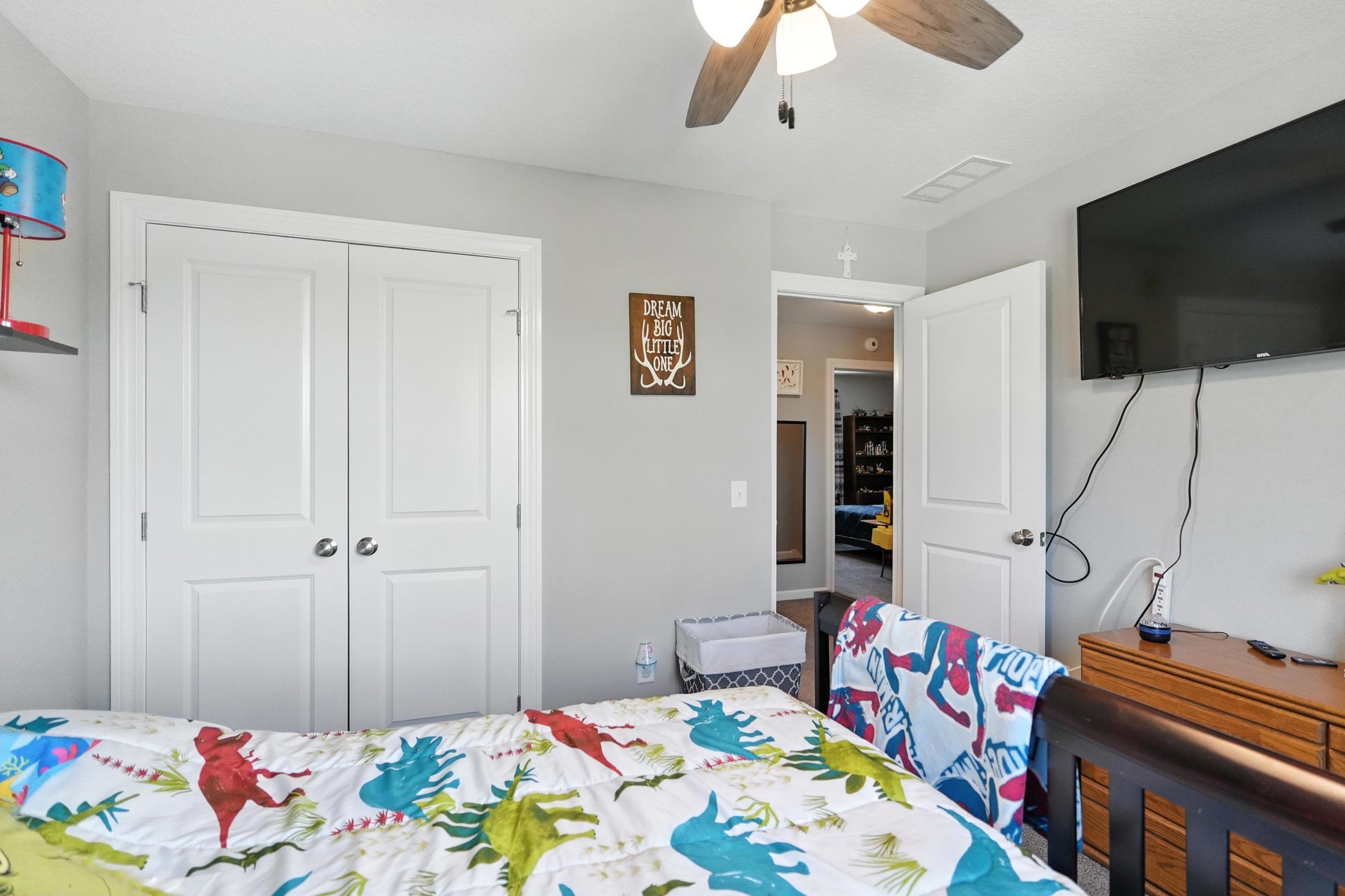Bedroom featuring a ceiling fan and a closet