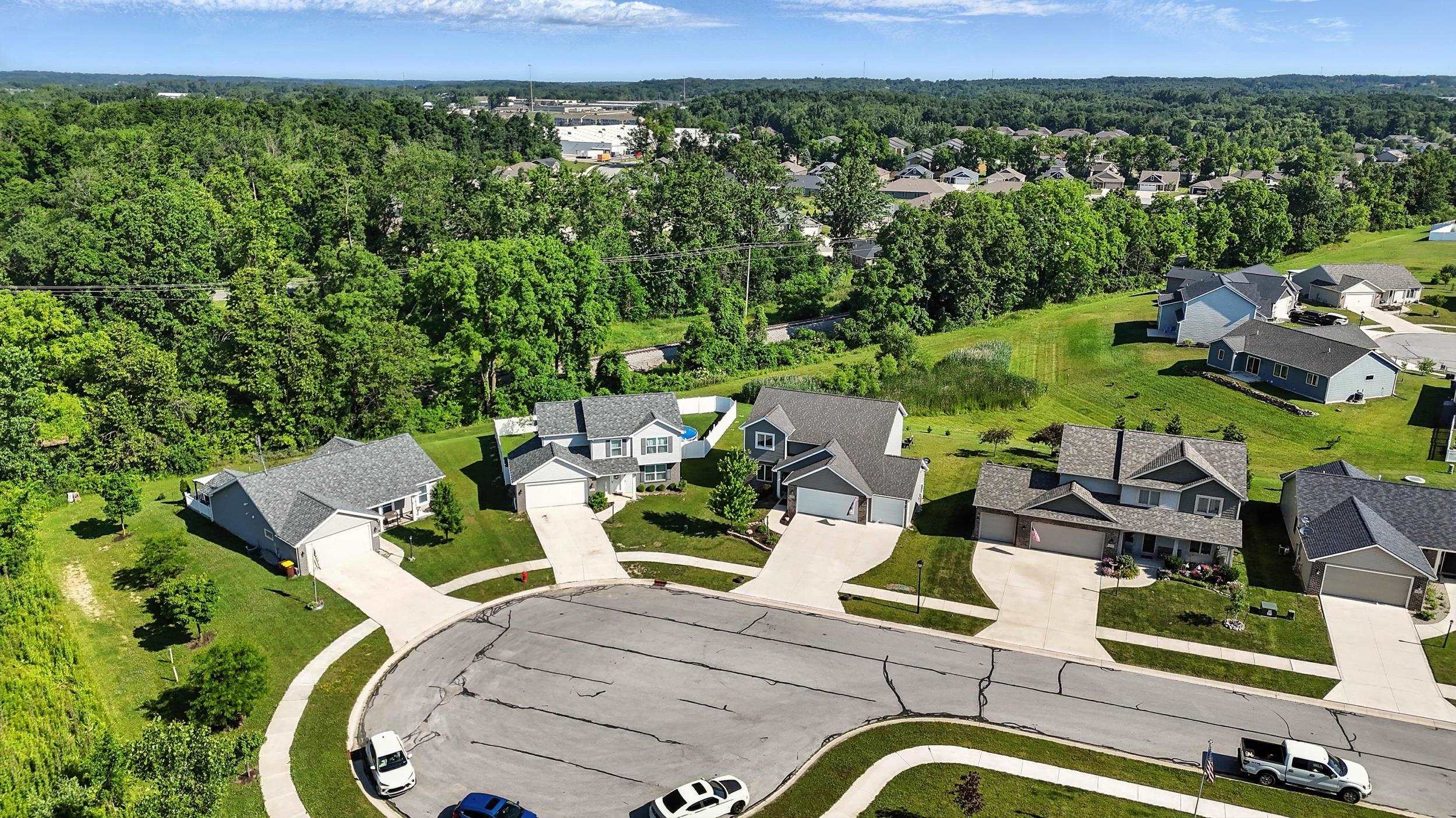 Aerial view of residential area featuring a forest