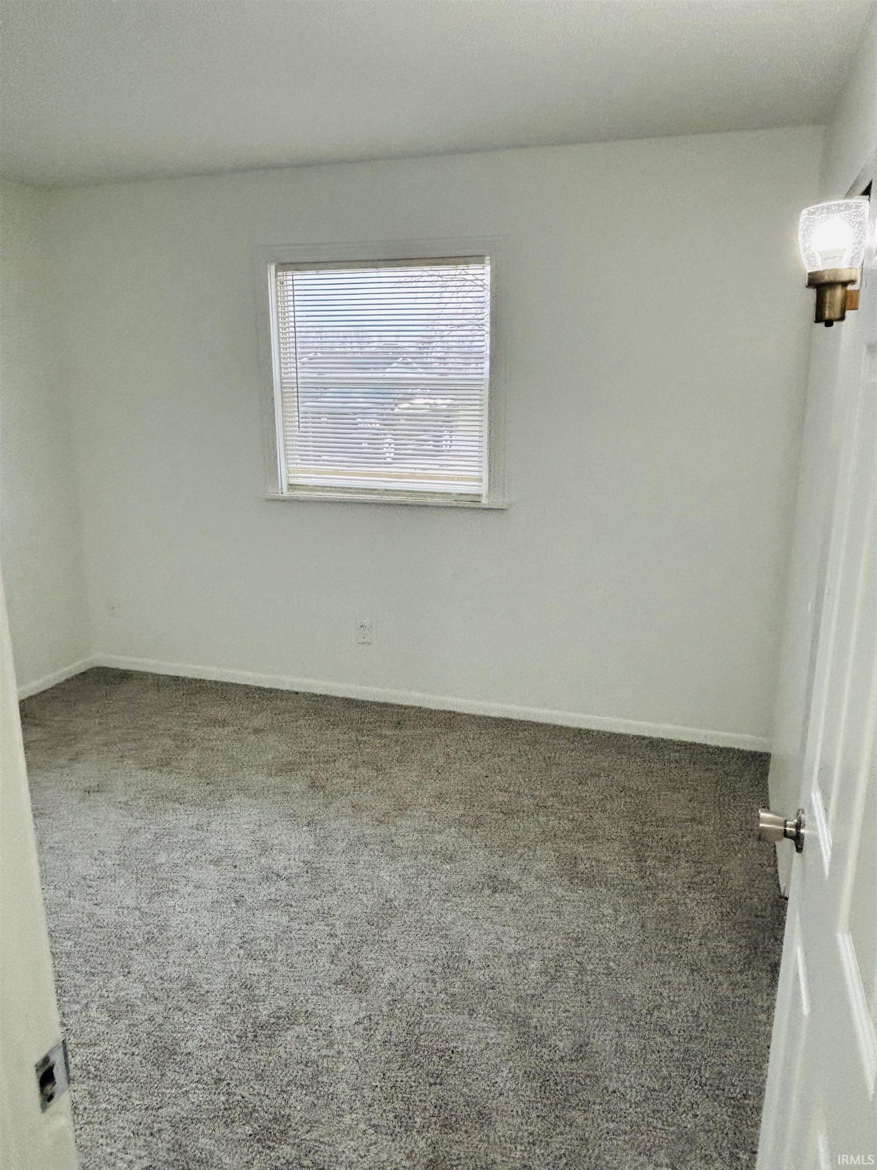 Empty room with carpet floors