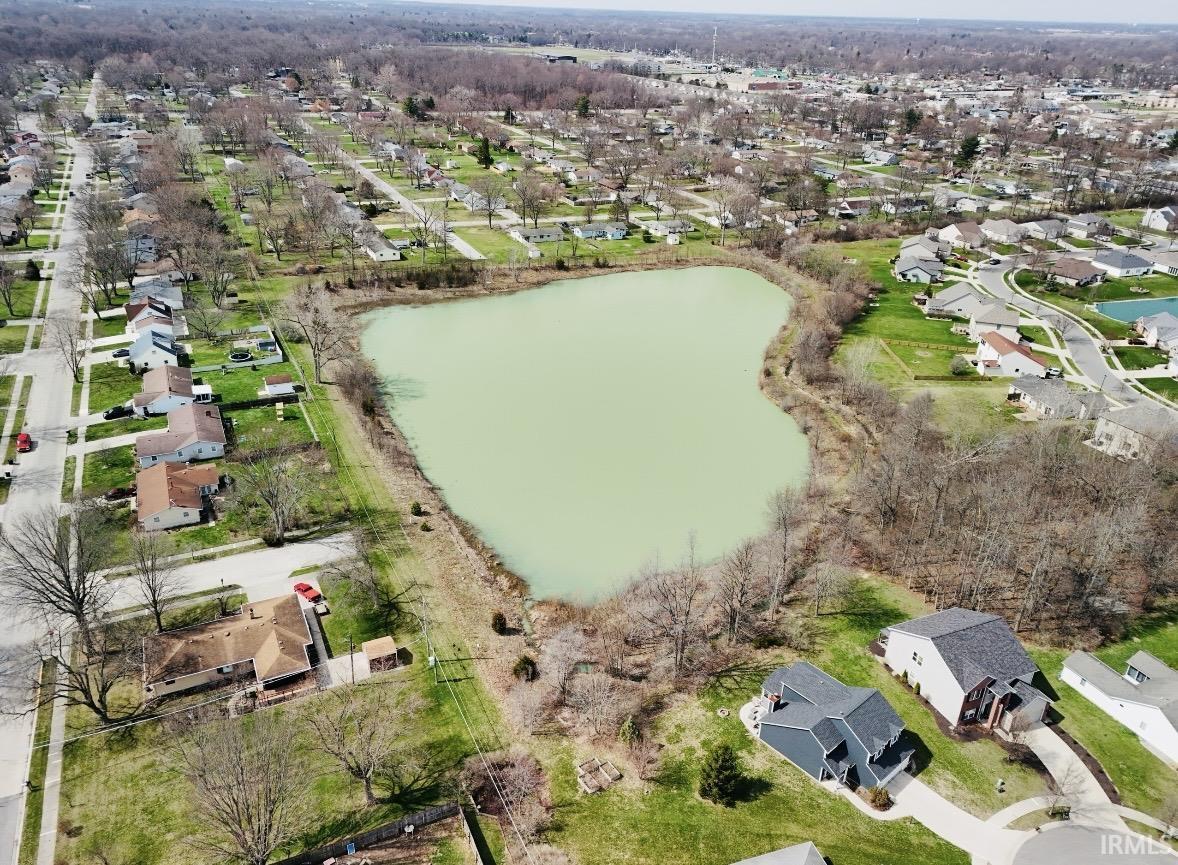 Aerial view of property's location featuring nearby suburban area