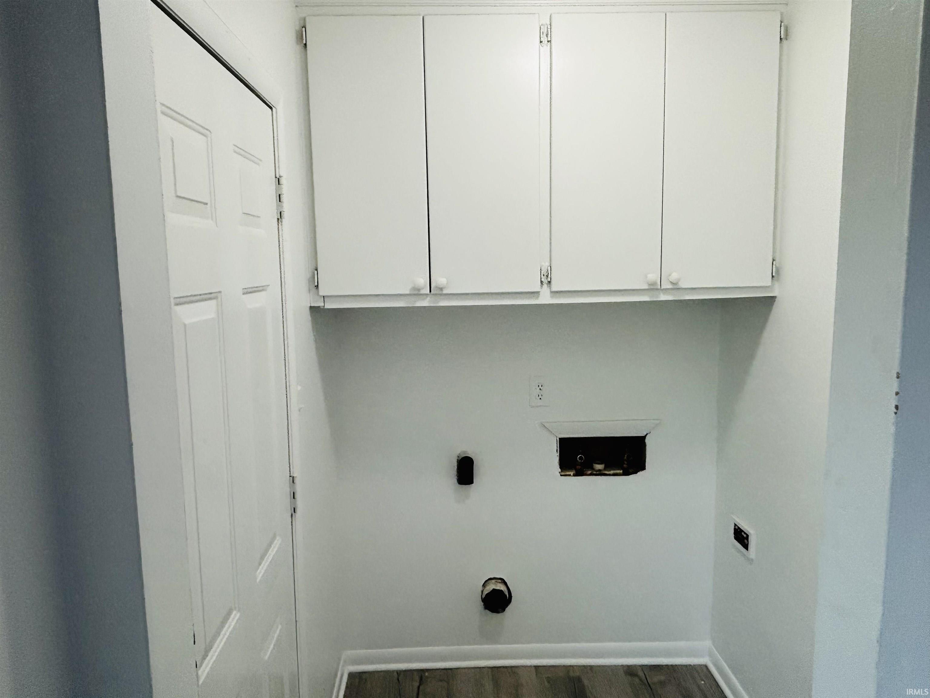 Laundry room with hookup for a washing machine, cabinet space, dark wood-style floors, and hookup for an electric dryer