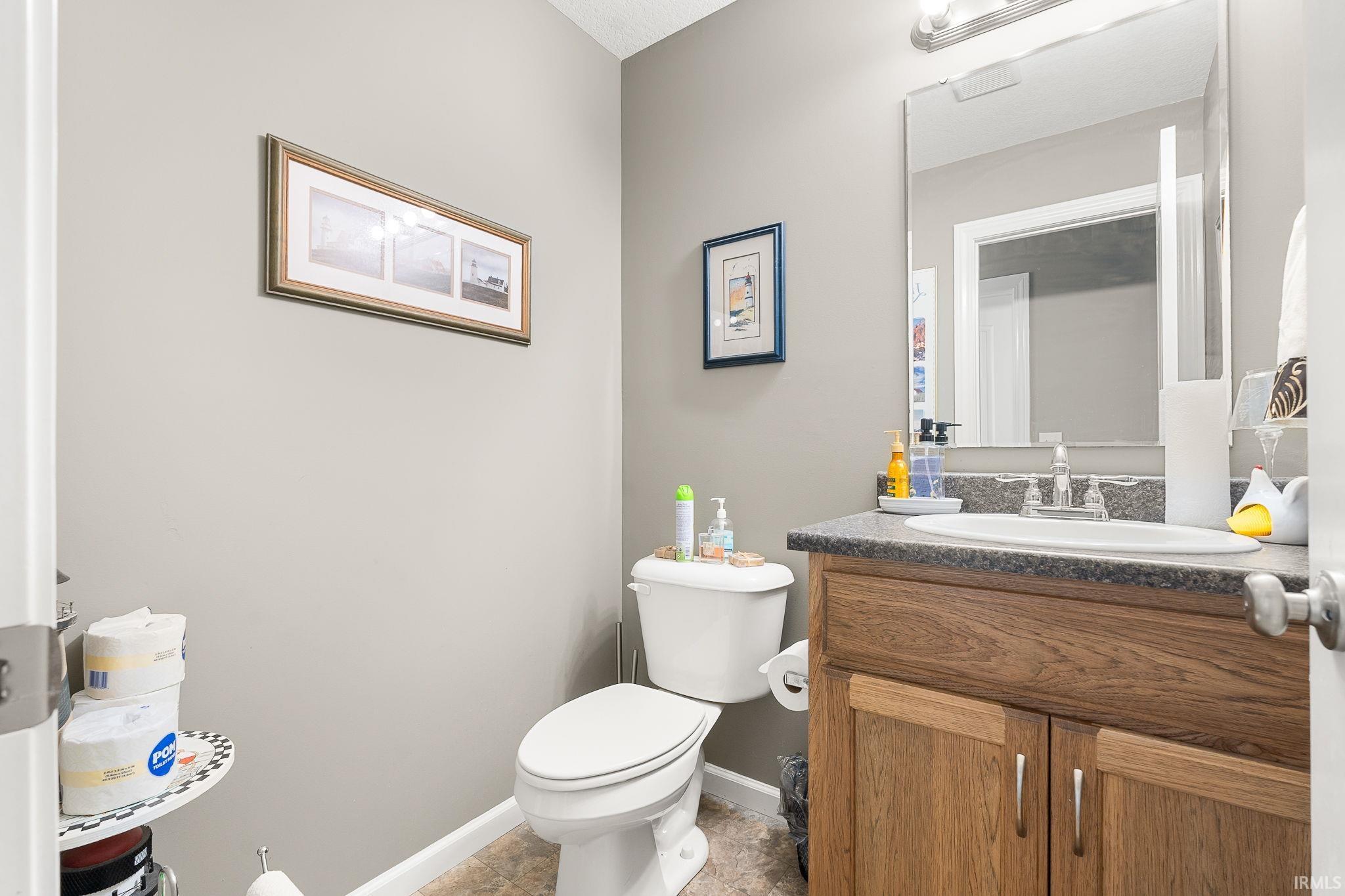 Half bath featuring toilet and vanity