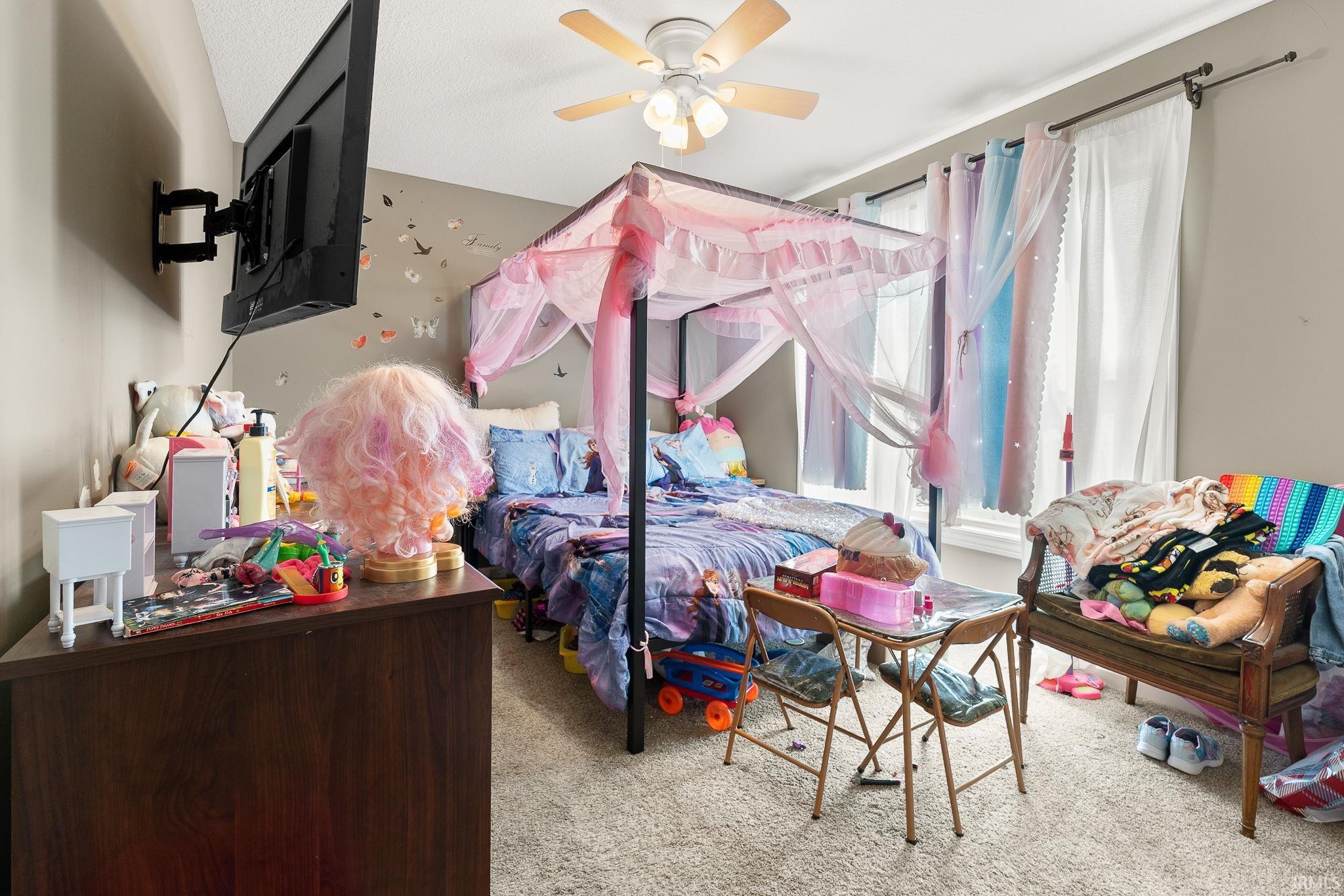 Carpeted bedroom with ceiling fan