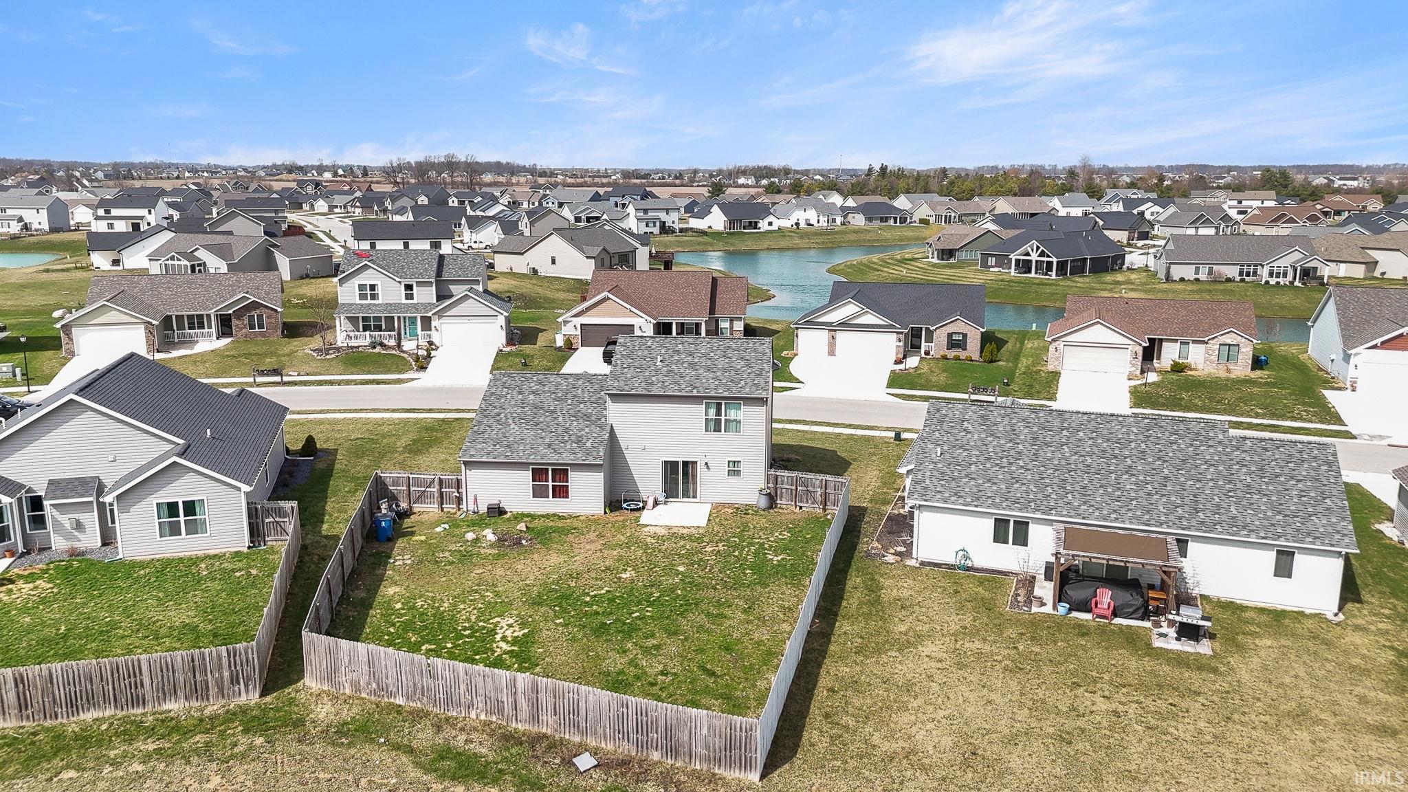 Aerial view of residential area featuring a large body of water