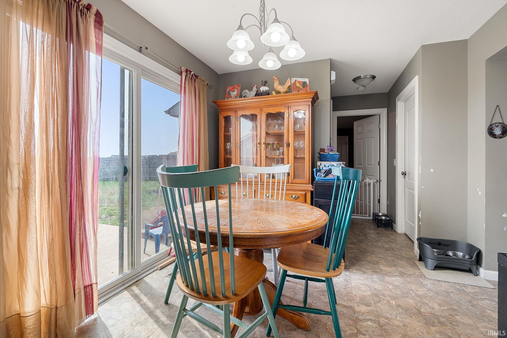Dining area with hanging lights and stone finish floors