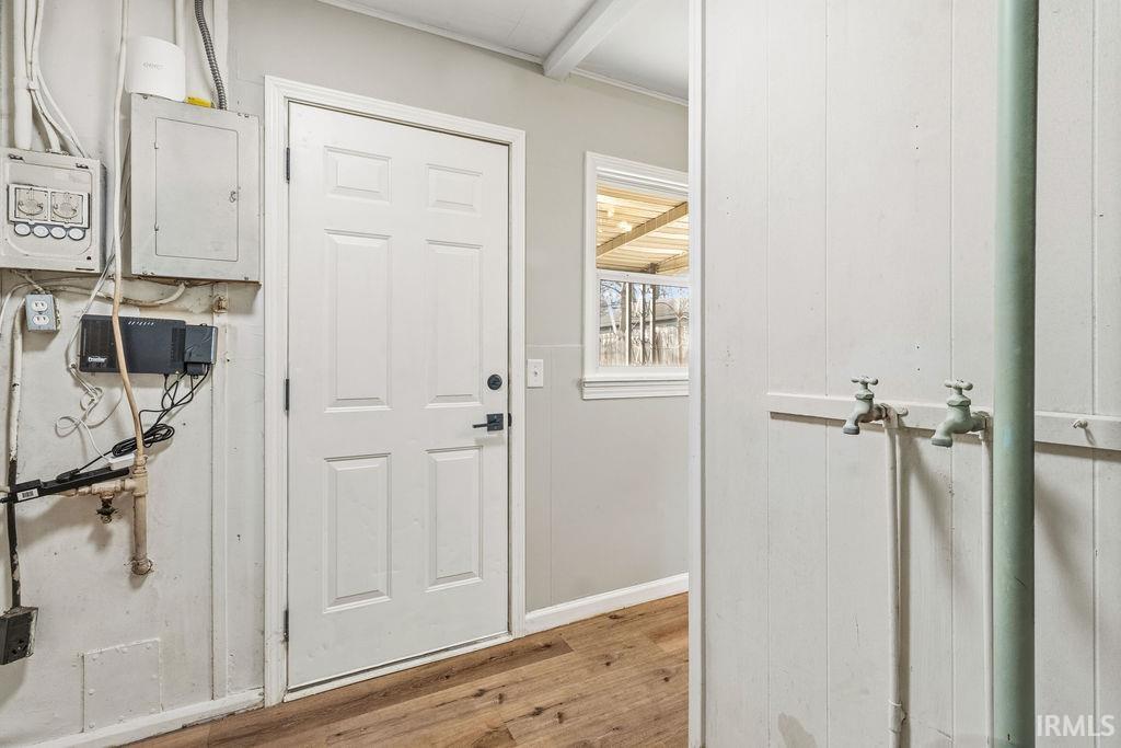 Entryway with electric panel and wood finished floors