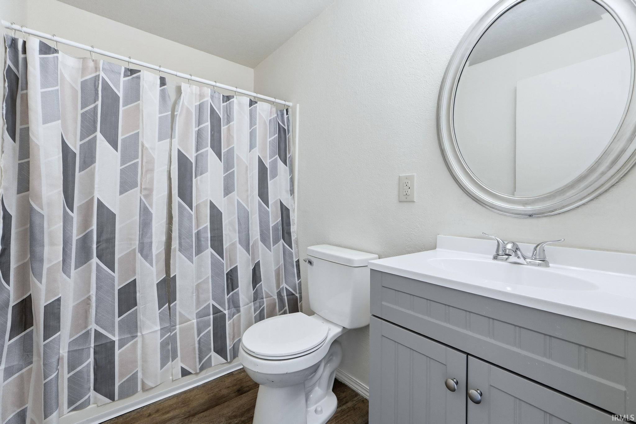 Bathroom featuring vanity and dark wood-style flooring