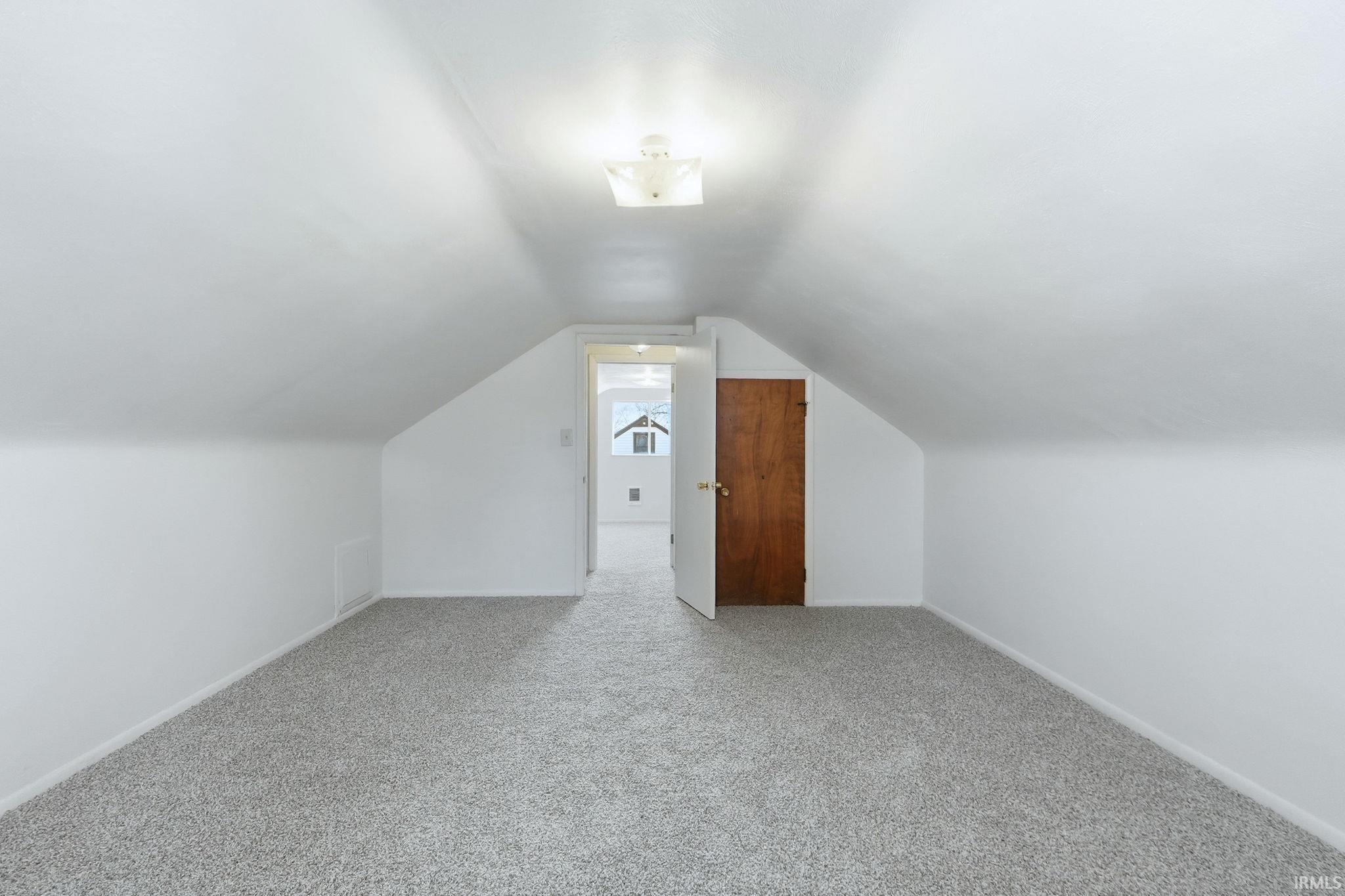 Bonus room featuring carpet floors and baseboards