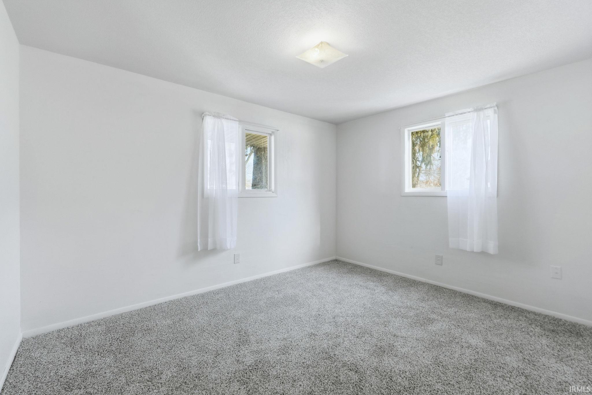 Spare room with carpet and plenty of natural light