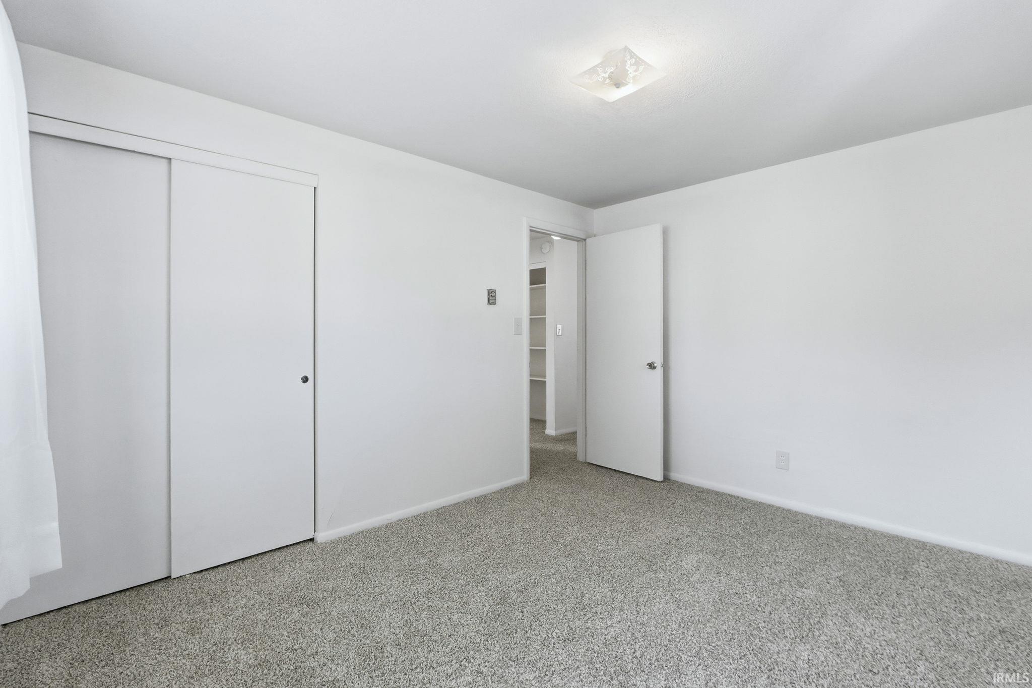 Unfurnished bedroom featuring carpet floors and a closet