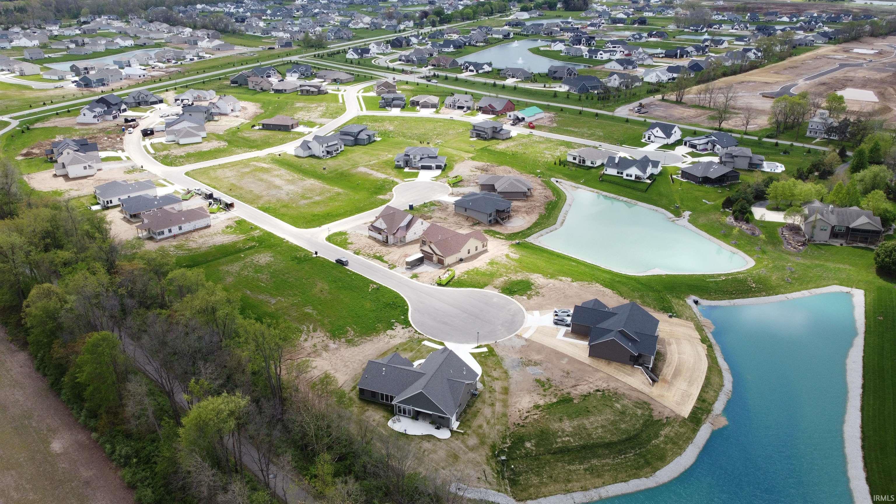 Aerial overview of a developing residential community featuring numerous single-family homes